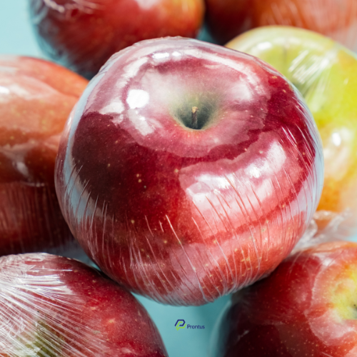 red apple wrapped in plastic to highlight wasteful packaging and single plastic use