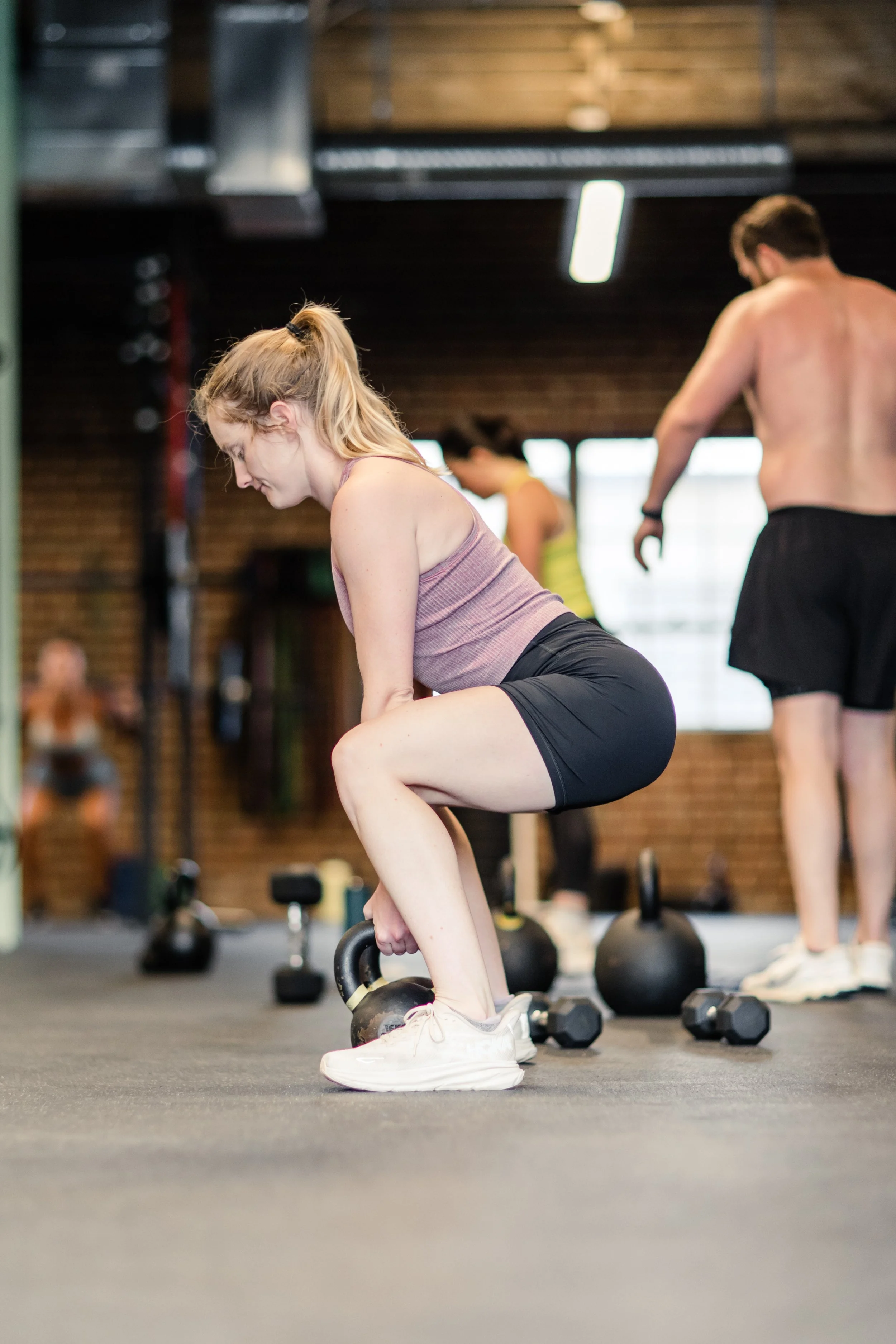 Women squatting with a kettlebell