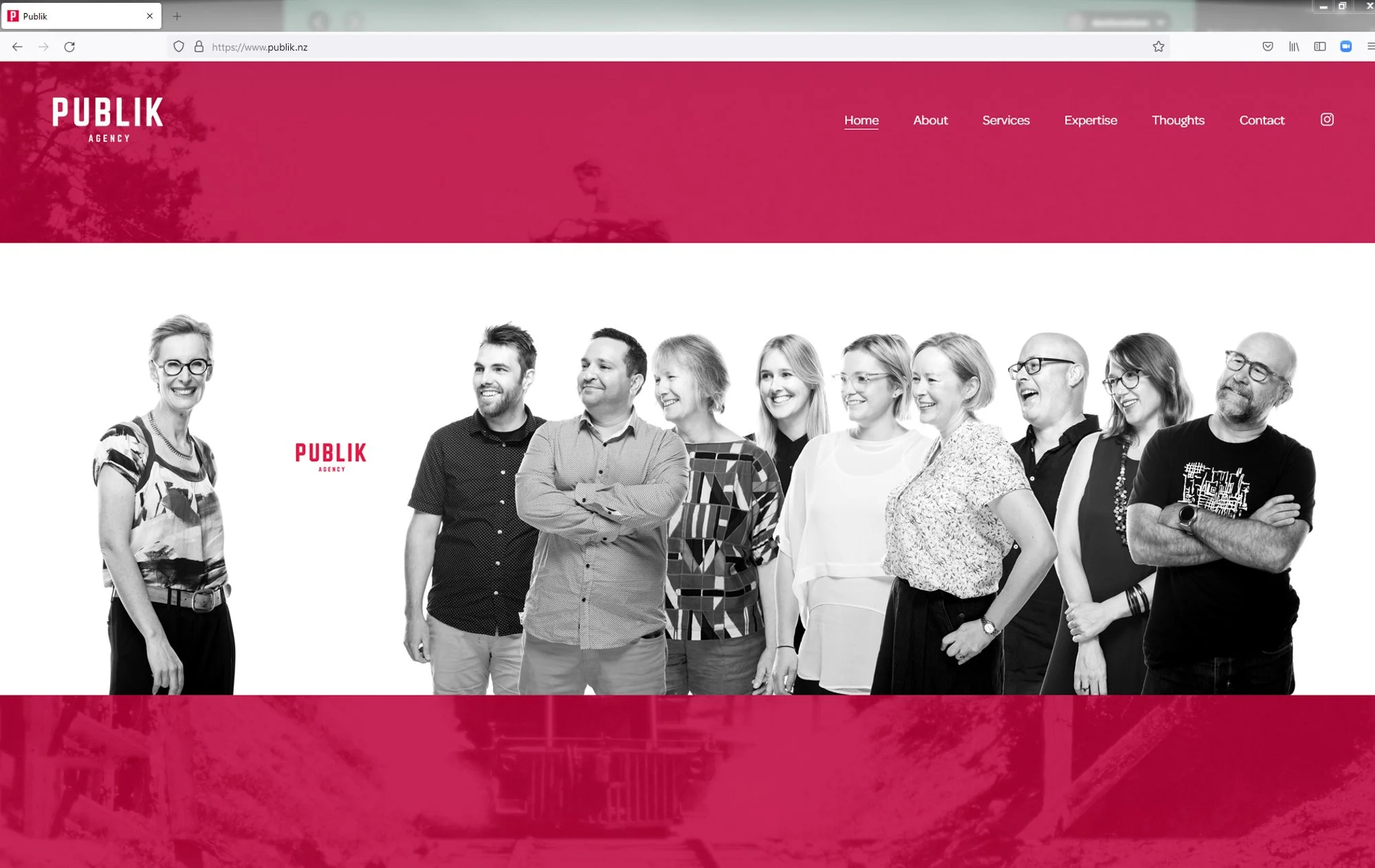 A group of ten diverse smiling people standing in a row under a pink header on a website, with the words 'PUBLIK AGENCY' on the left side.