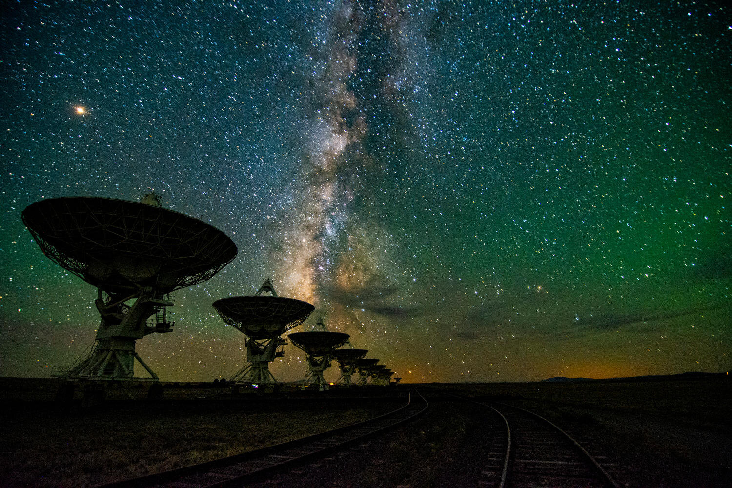 The Milky Way Galaxy seen over the Karl G. Jansky Very Large Array west of Socorro, New Mexico.  Photo by NRAO/AUI/NSF, Jeff Hellerman