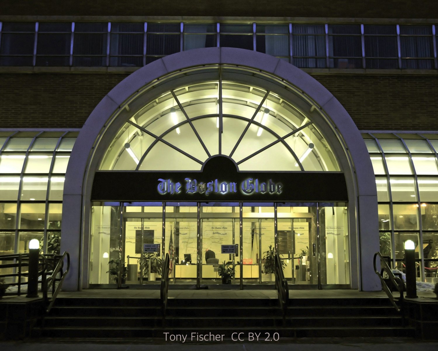 The facade of The Boston Globe building at night