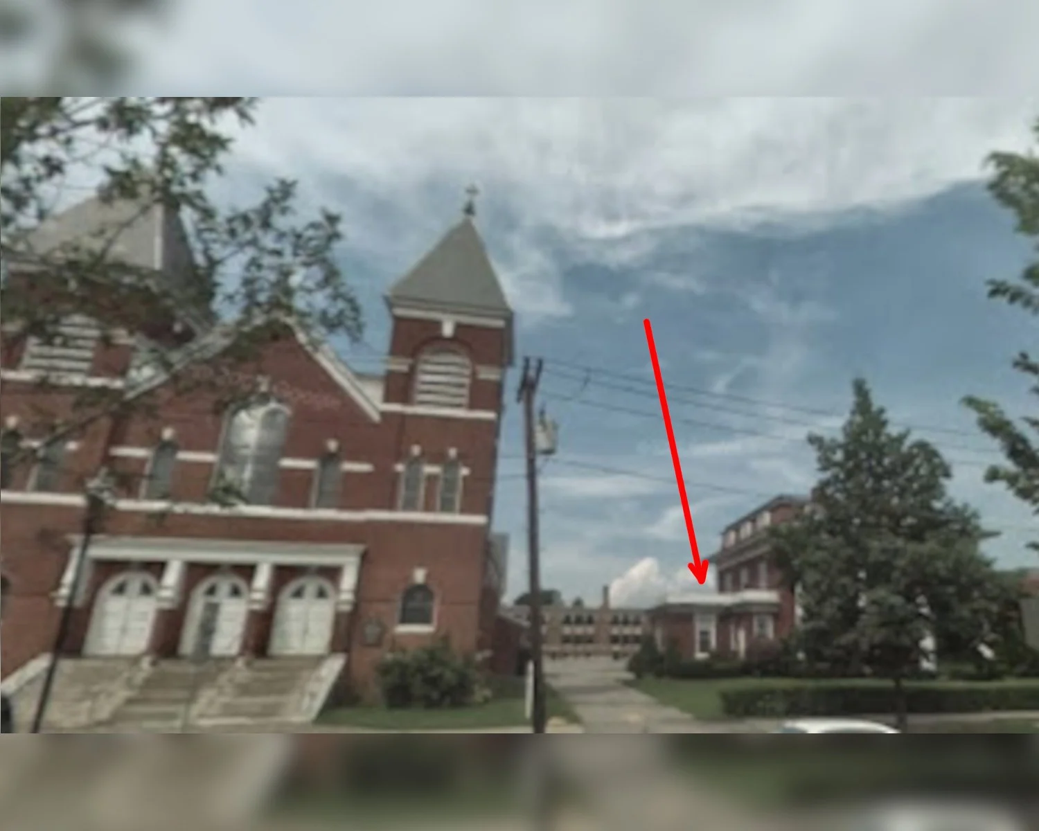 View of Saint Bernard Church and Rectory in Keene, New Hampshire.  The arrow points to where alleged sexual abuse happened.