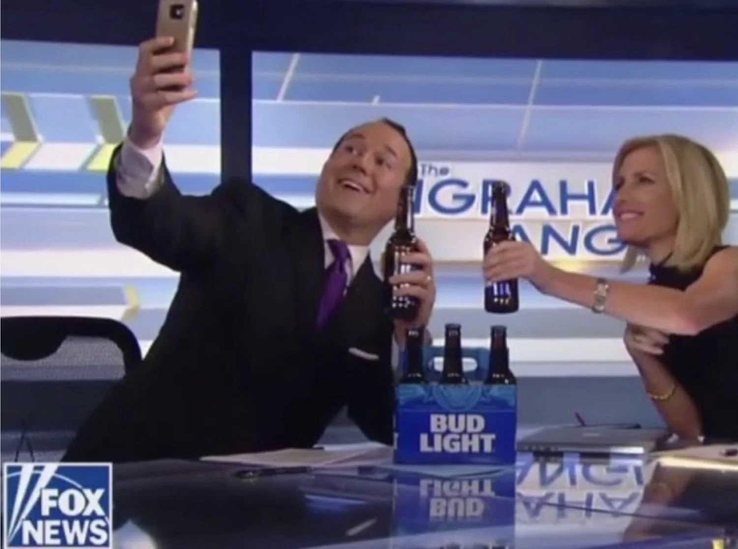 Raymond Arroyo taking a selfie of himself toasting with Laura Ingraham