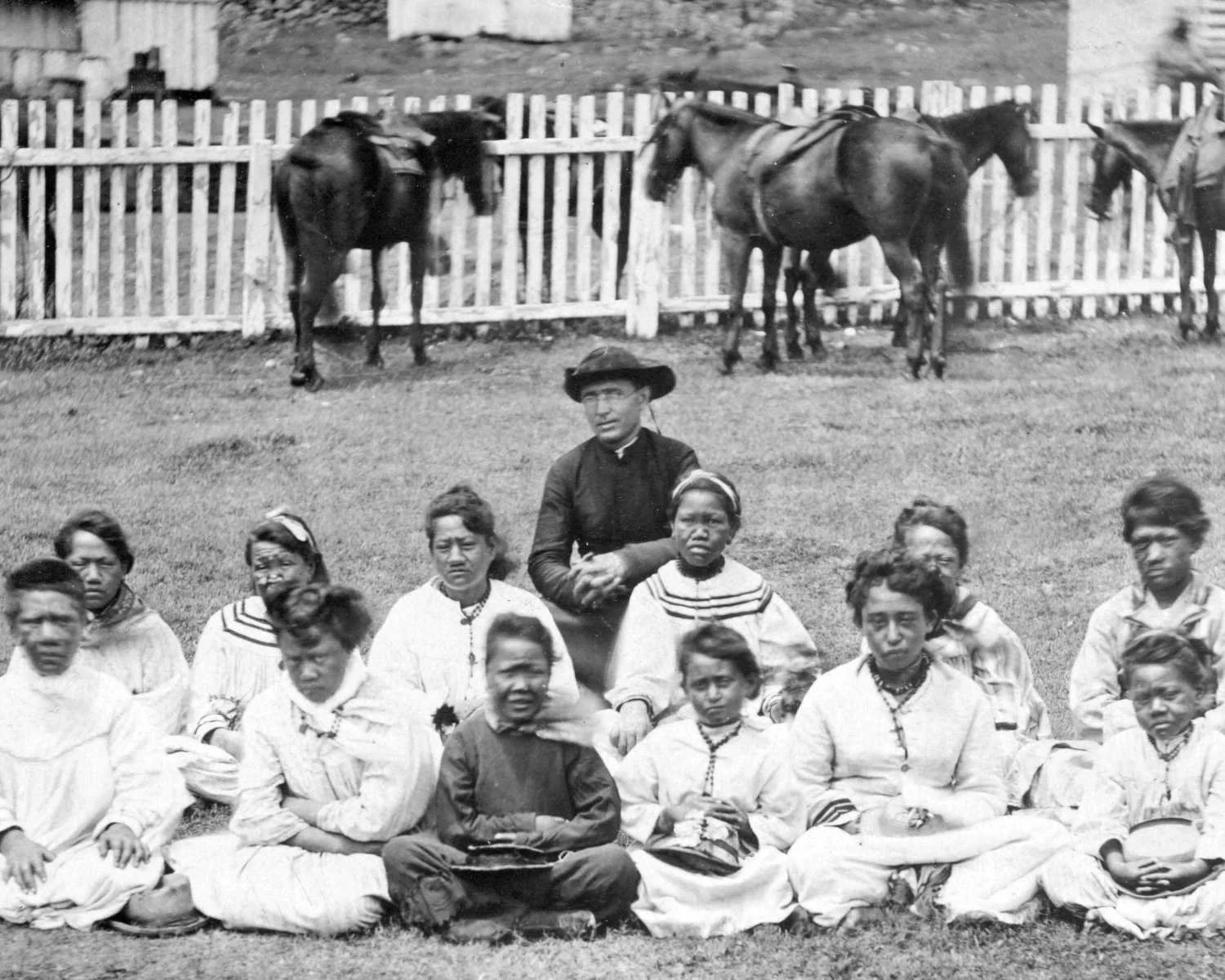 Father Damien with the Kalawao Girls Choir.  Horses behind them.