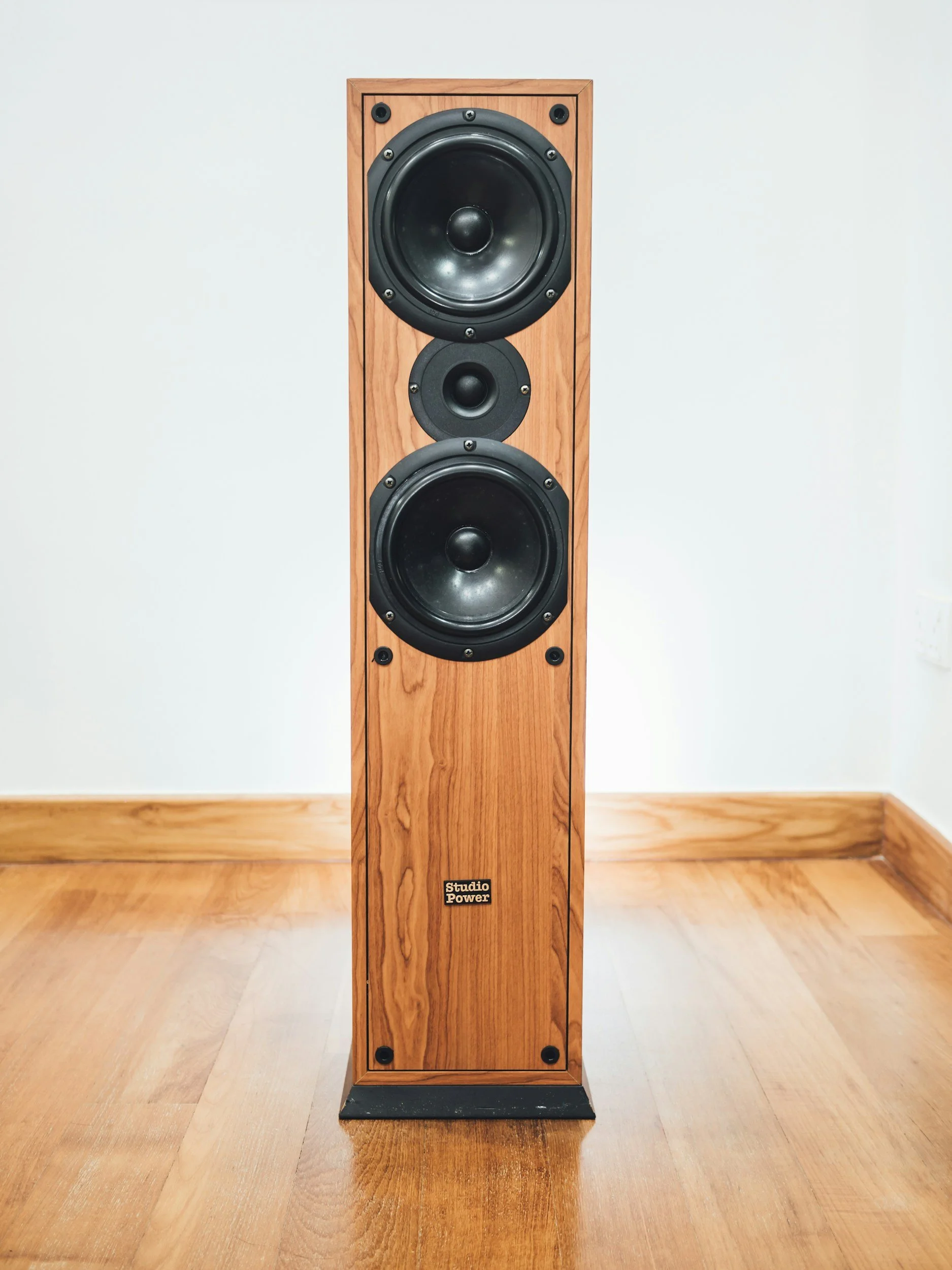 speaker tower with a wood finish