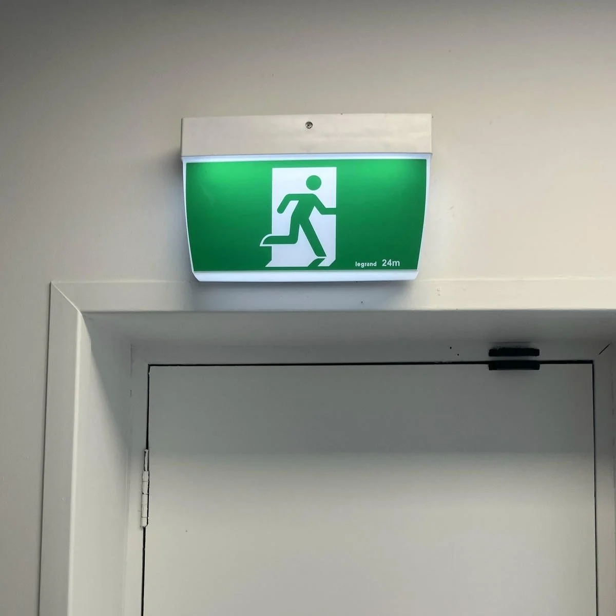 emergency-exit-sign-over-door-of-common-area-in-strata-managed-building.jpeg