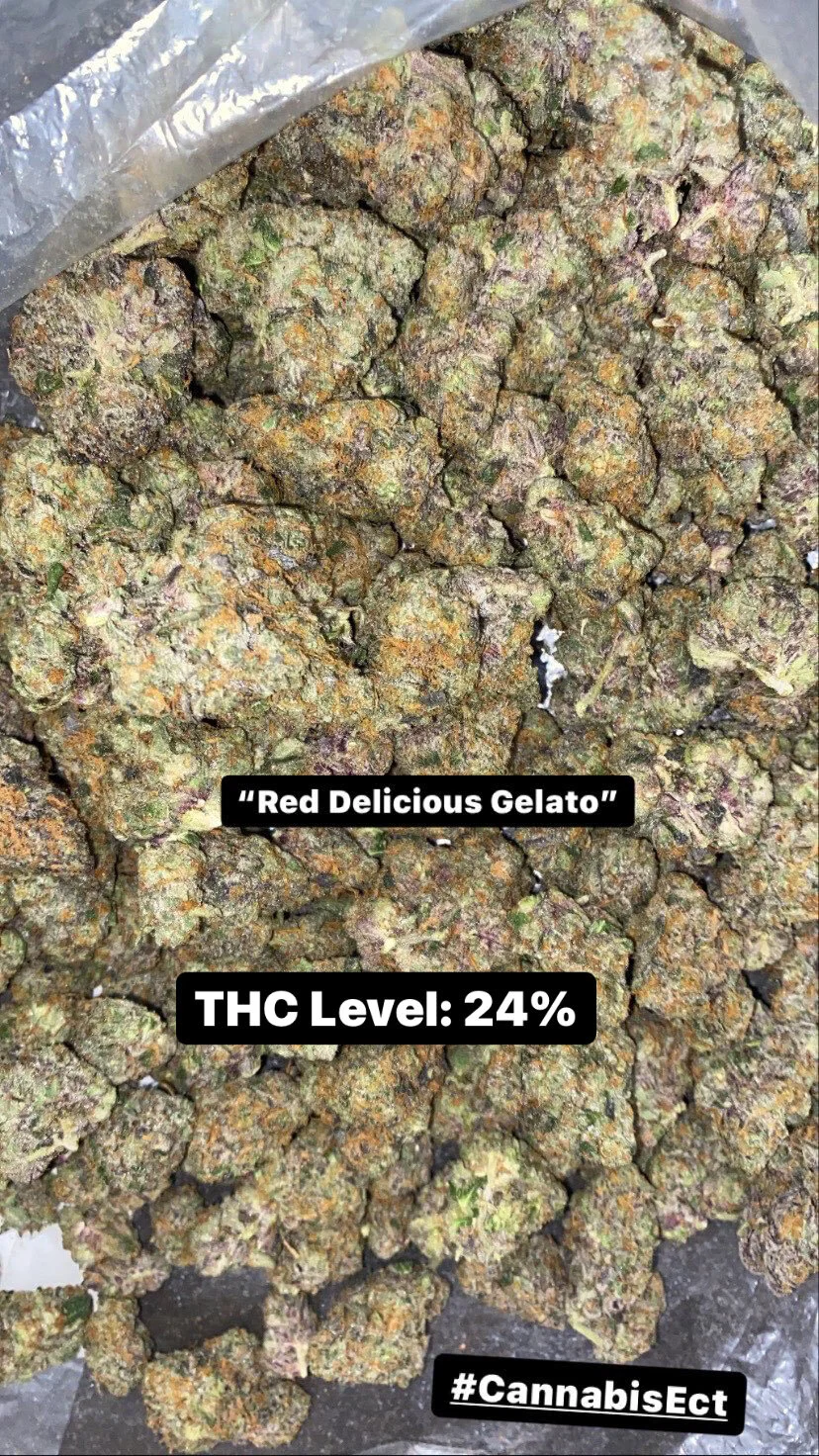 Close-up image of cannabis buds with a label indicating 'Red Delicious Gelato' with a THC level of 24%, for display.