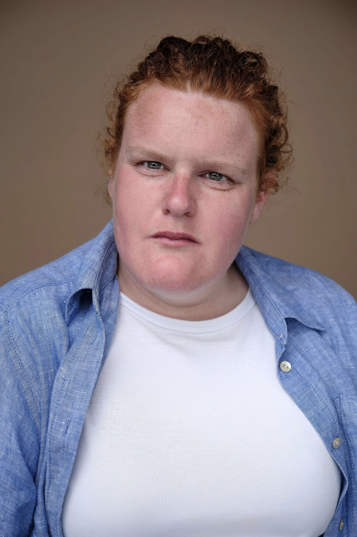 Headshot of actor Holly. Holly is a white female between the ages of 22-42. she has ginger curly hair