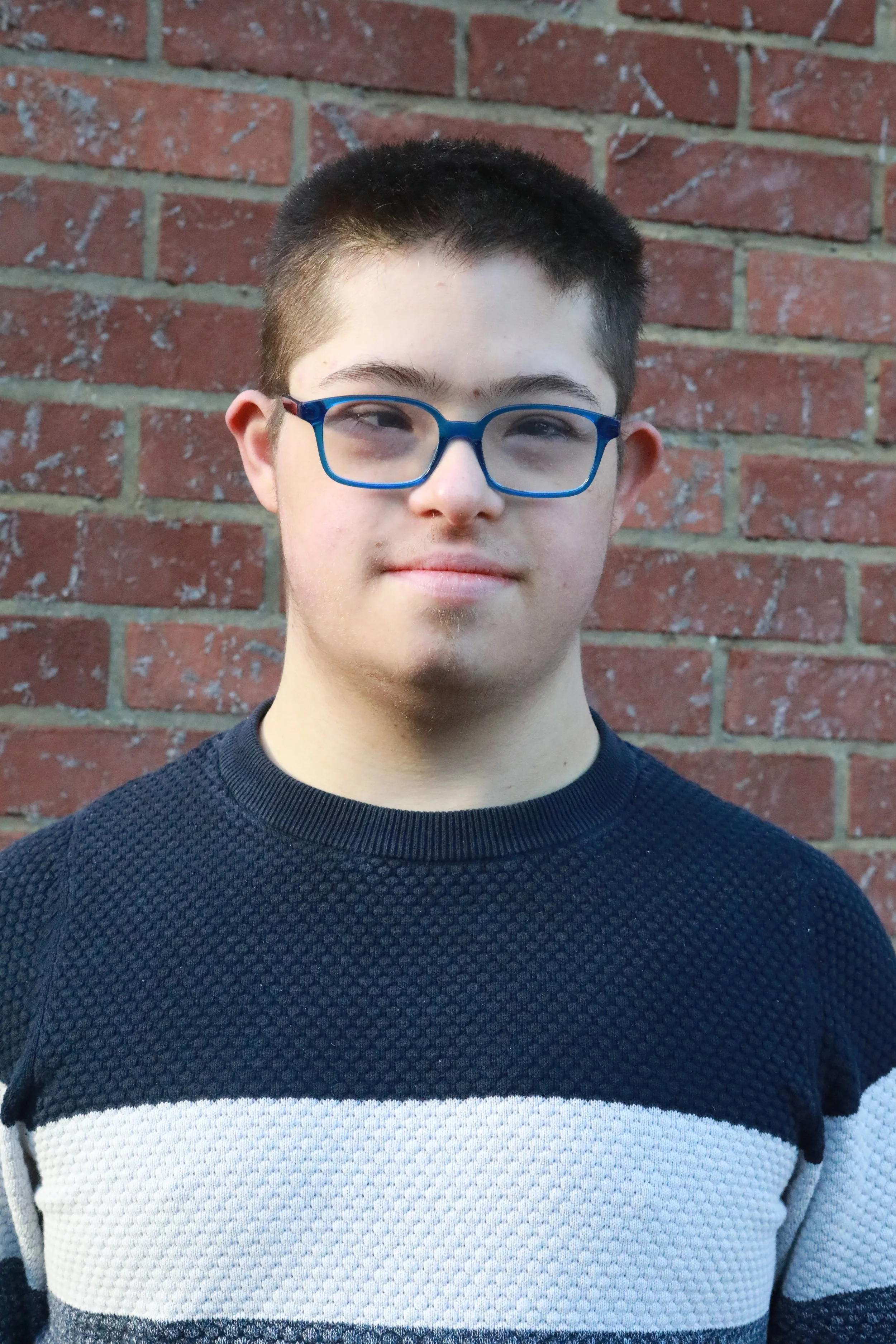 Joe is a white late teenage male with brown straight hair and has Down's syndrome