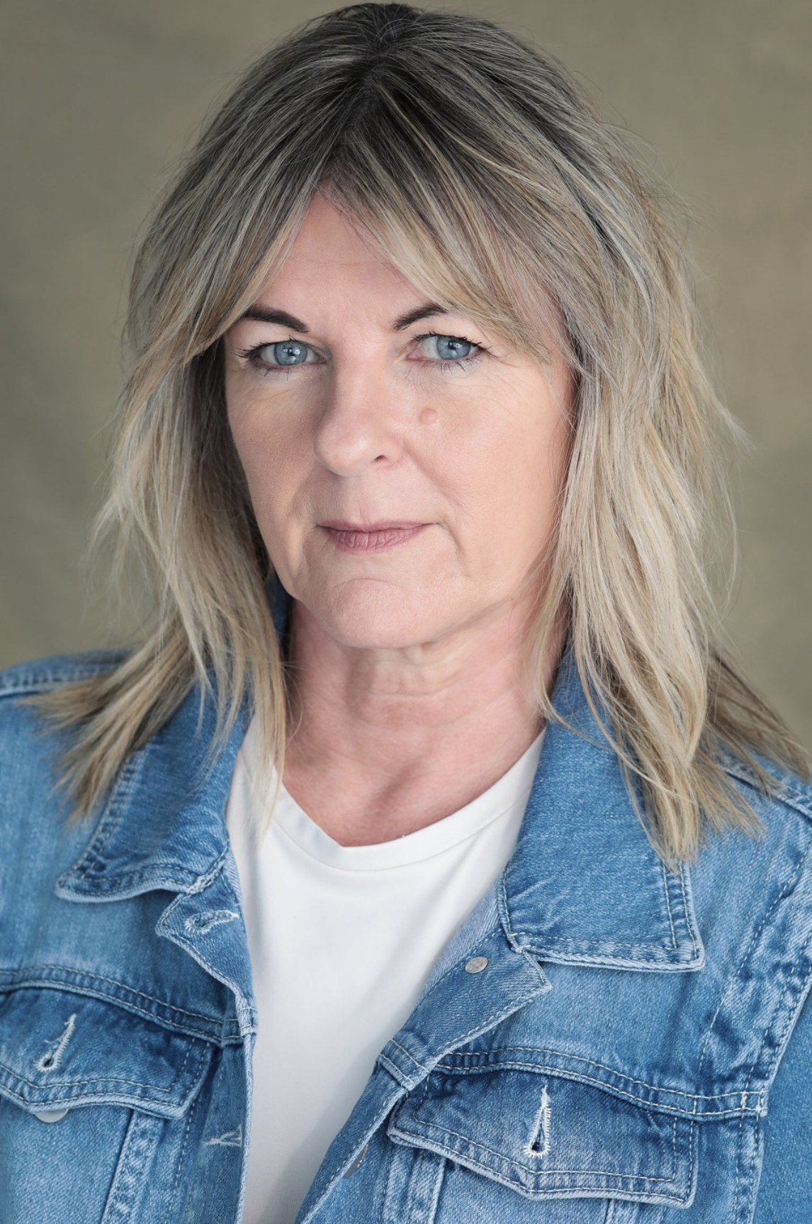 Headshot of actor Kat-Anne Rogers. Kat is a older white female with blonde shoulder length hair