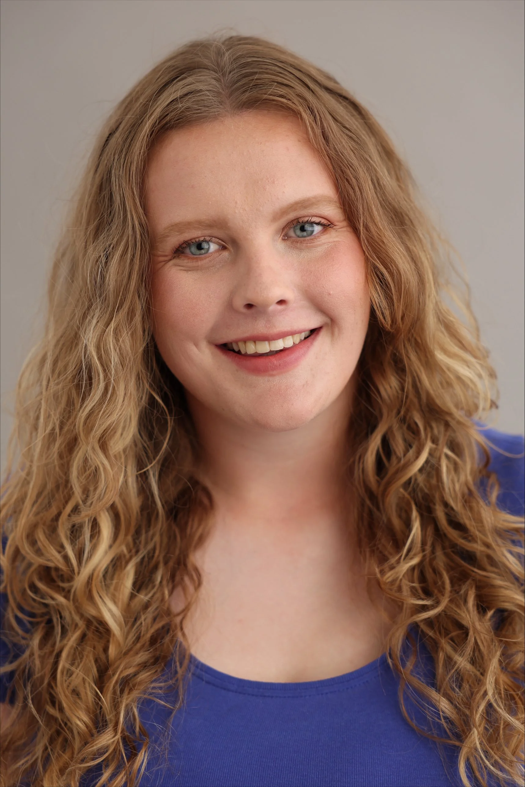 Headshot of Anna Hope-Wilson. Anna is a White, Northern Irish, Scottish, British female with light brown wavy hair. She is aged between 16-22