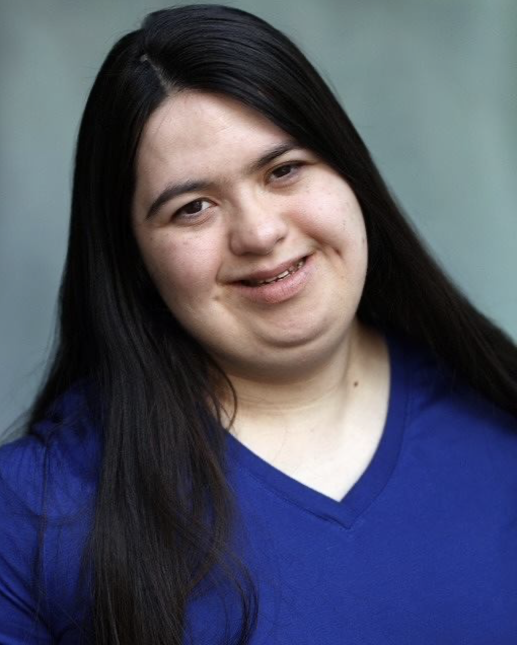 Headshot of actor Kirsty Harrower. Kirsty is a white/mixed race young adult female. She has dark brown hair. Kirsty has Down syndrome