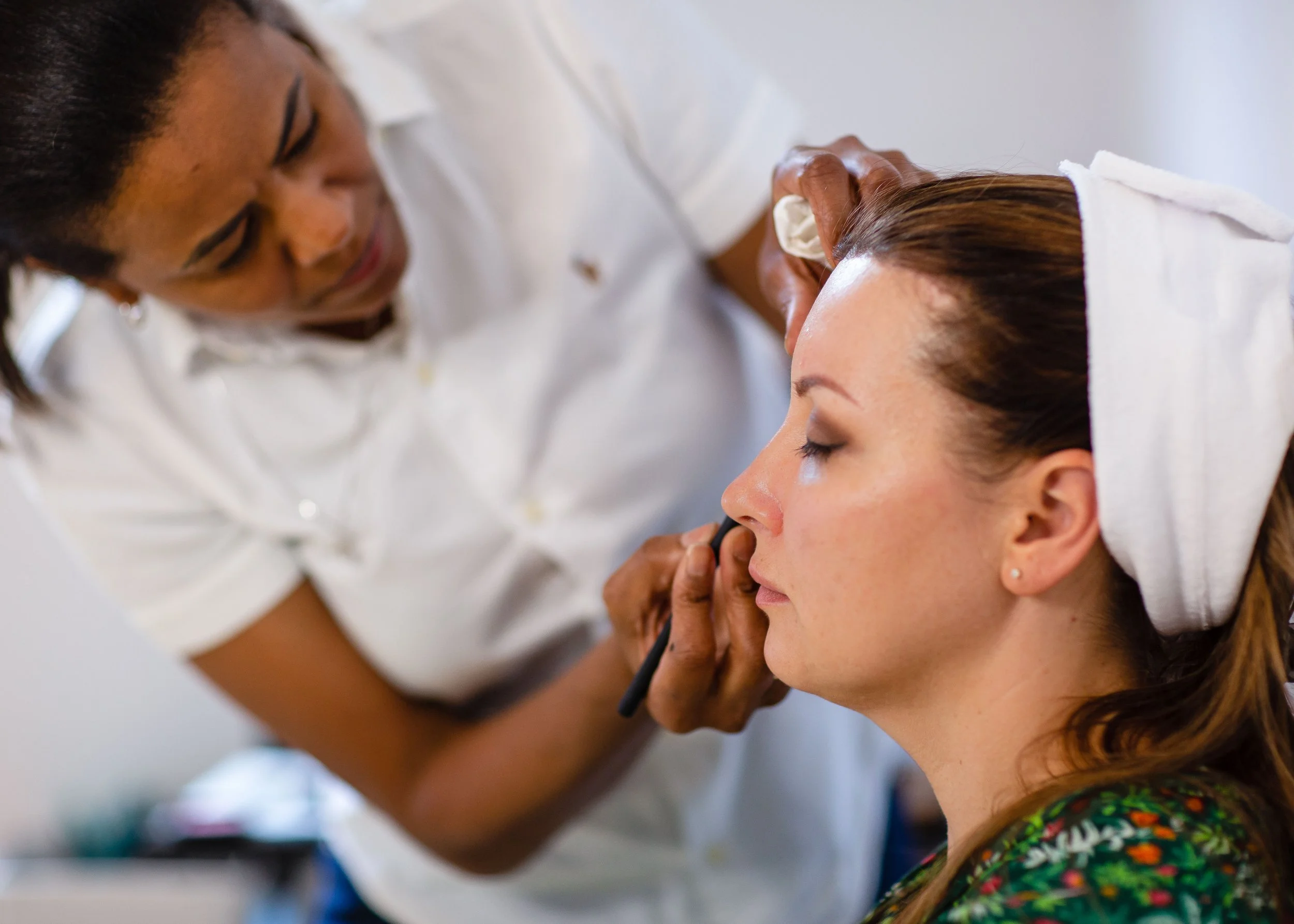 Professional Hair and make-up artist styling a client for. a photoshoot in a Stuttgart studio