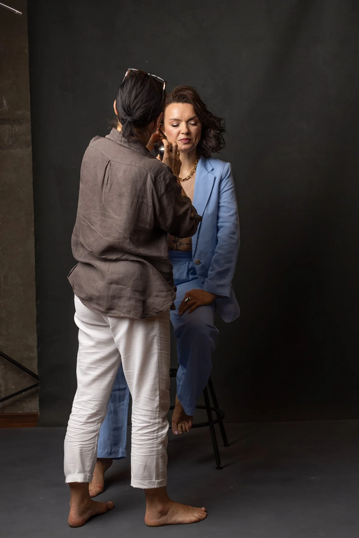 A female client is getting her hair fixed by a hair and make-up artists during a business photoshoot in Stuttgart, Germany.