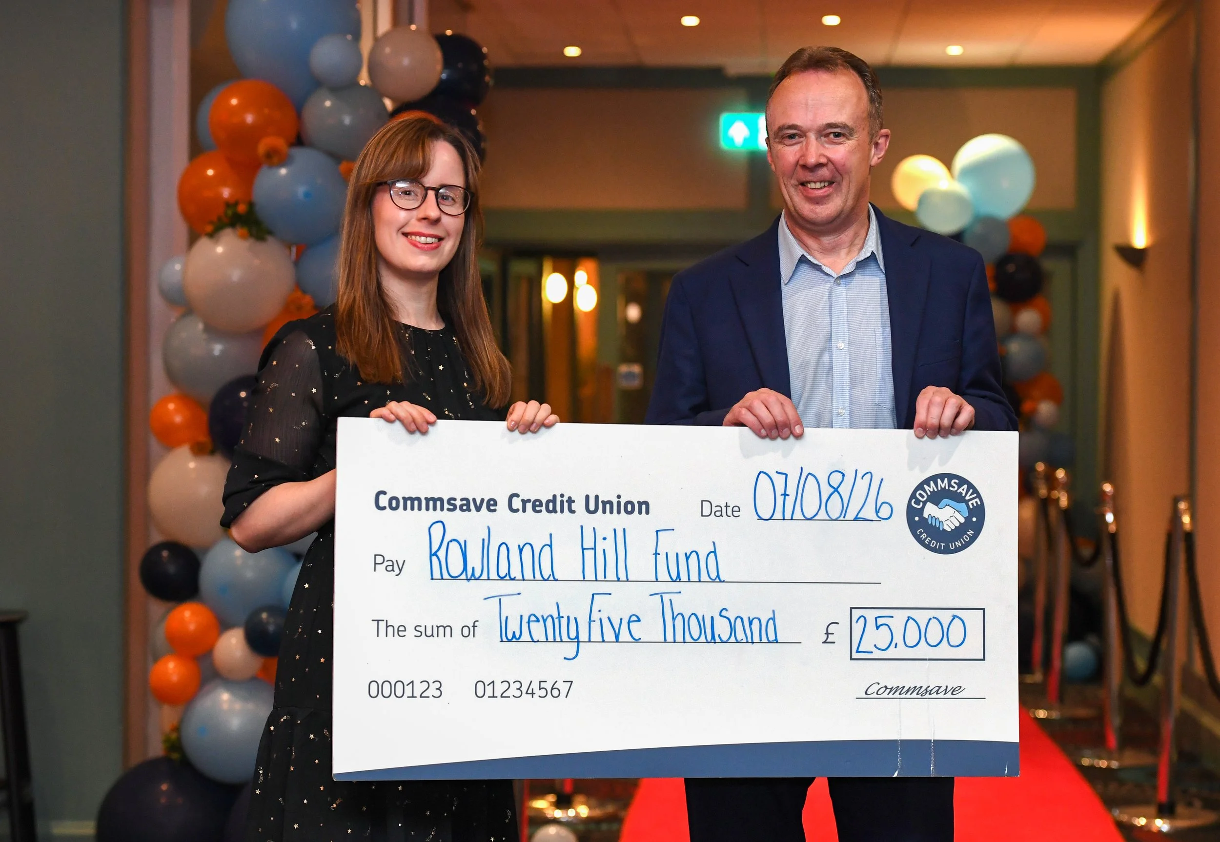 Image of Grace Owne and Matt Goulding holding a cheque