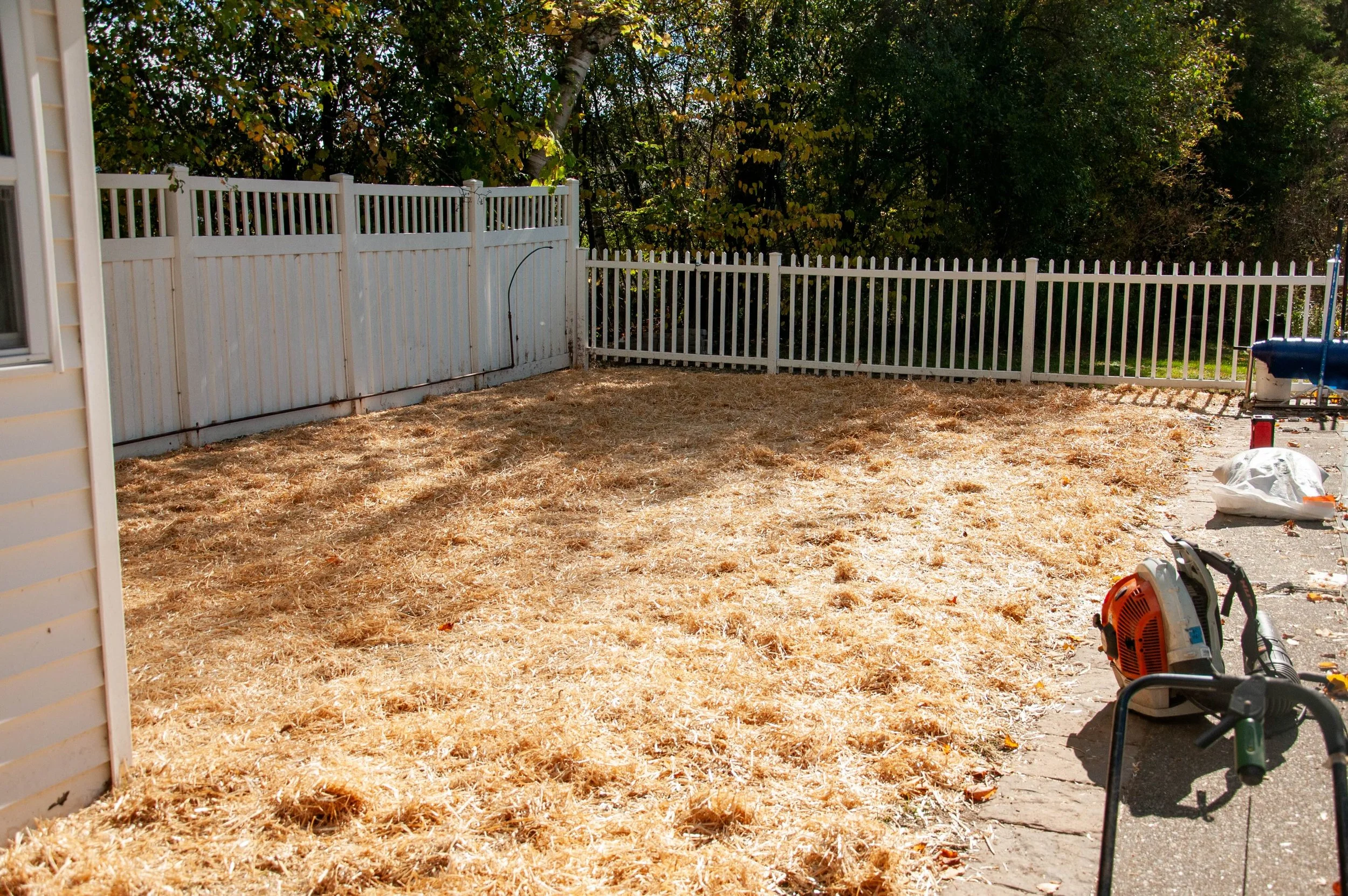 empty yard with hay laid for growing new grass