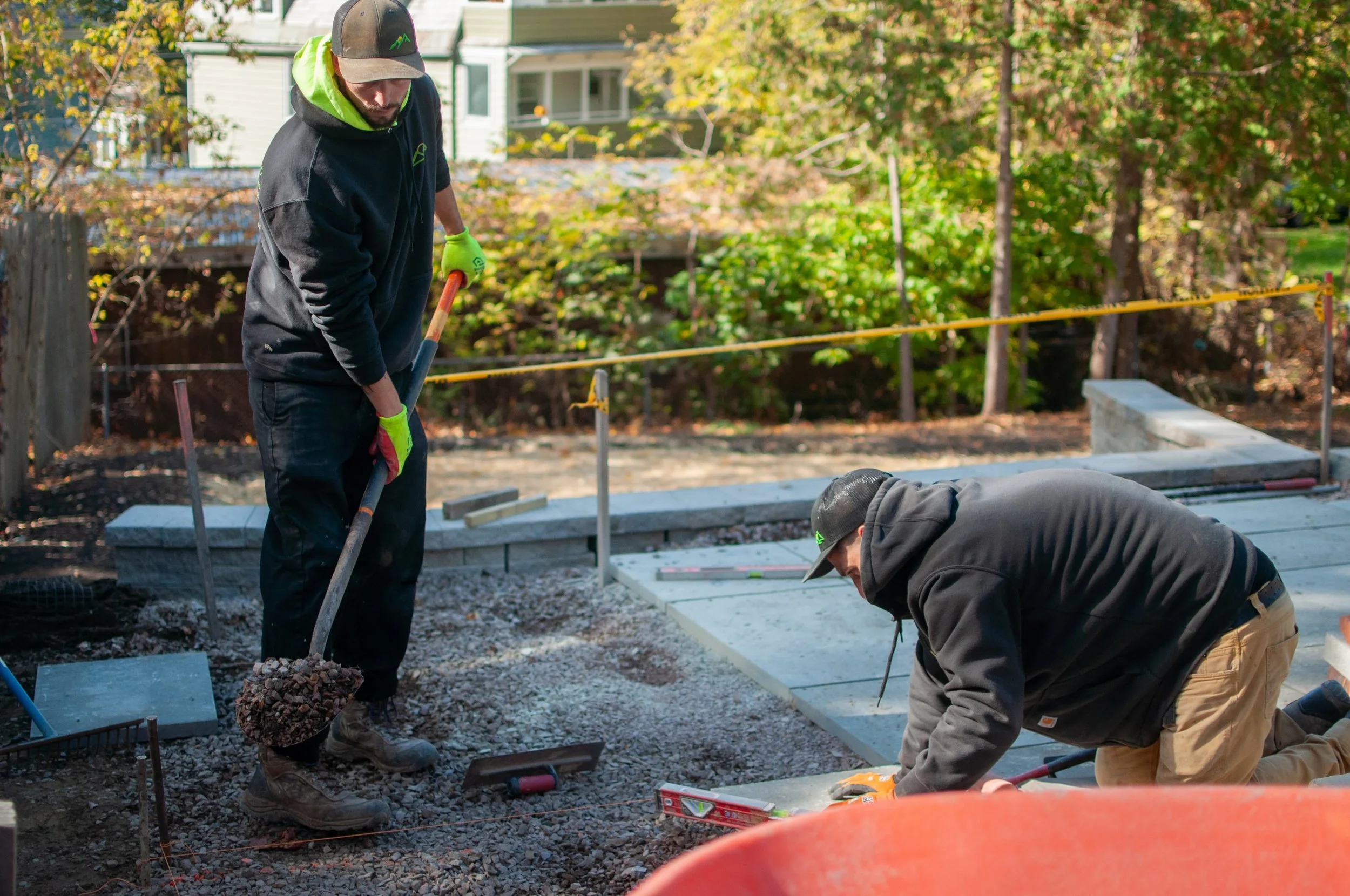 pinnacle properties landscapers laying down gravel beneath patio pavers