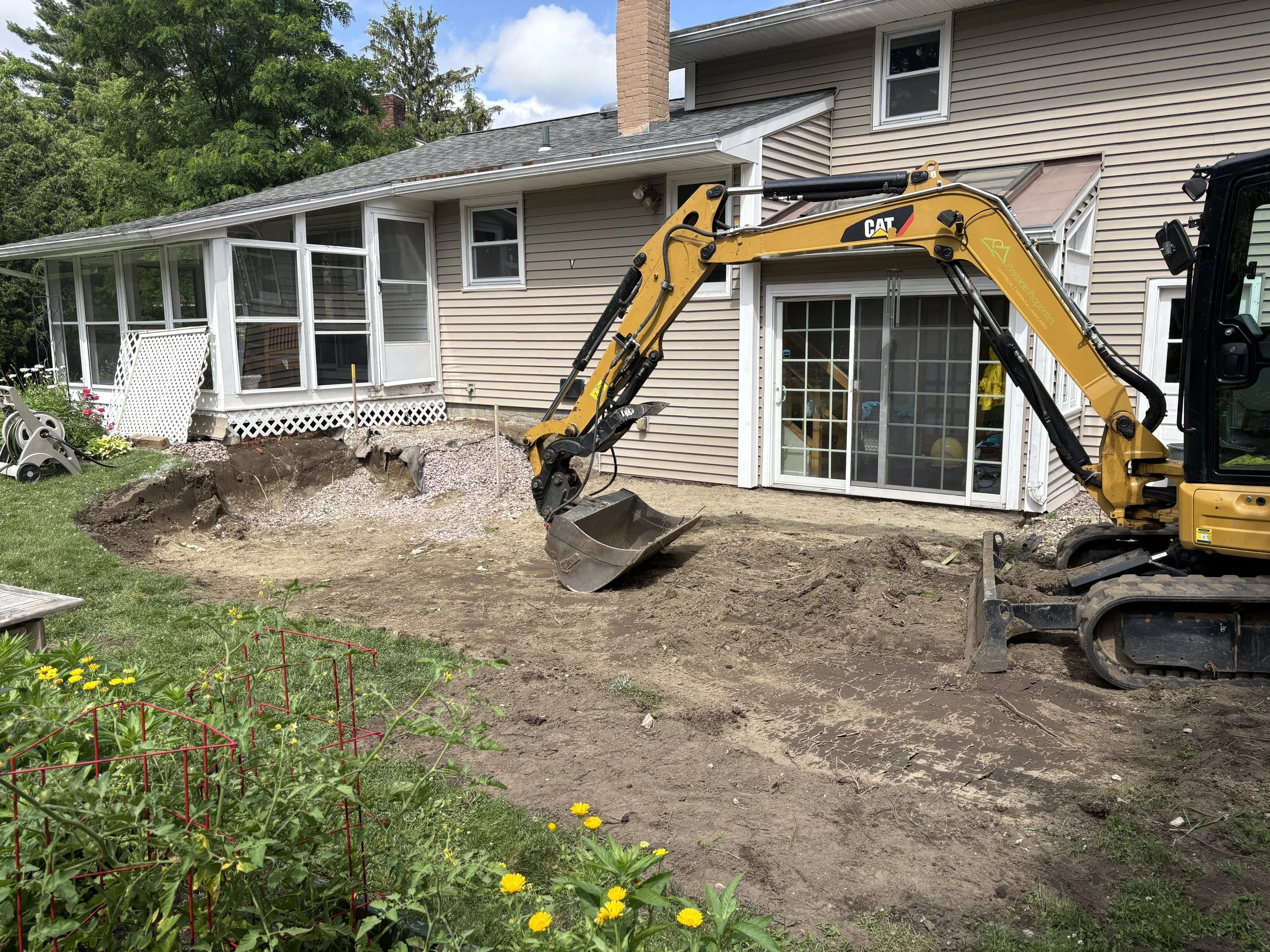 pinnacle properties excavator preparing ground for a new patio