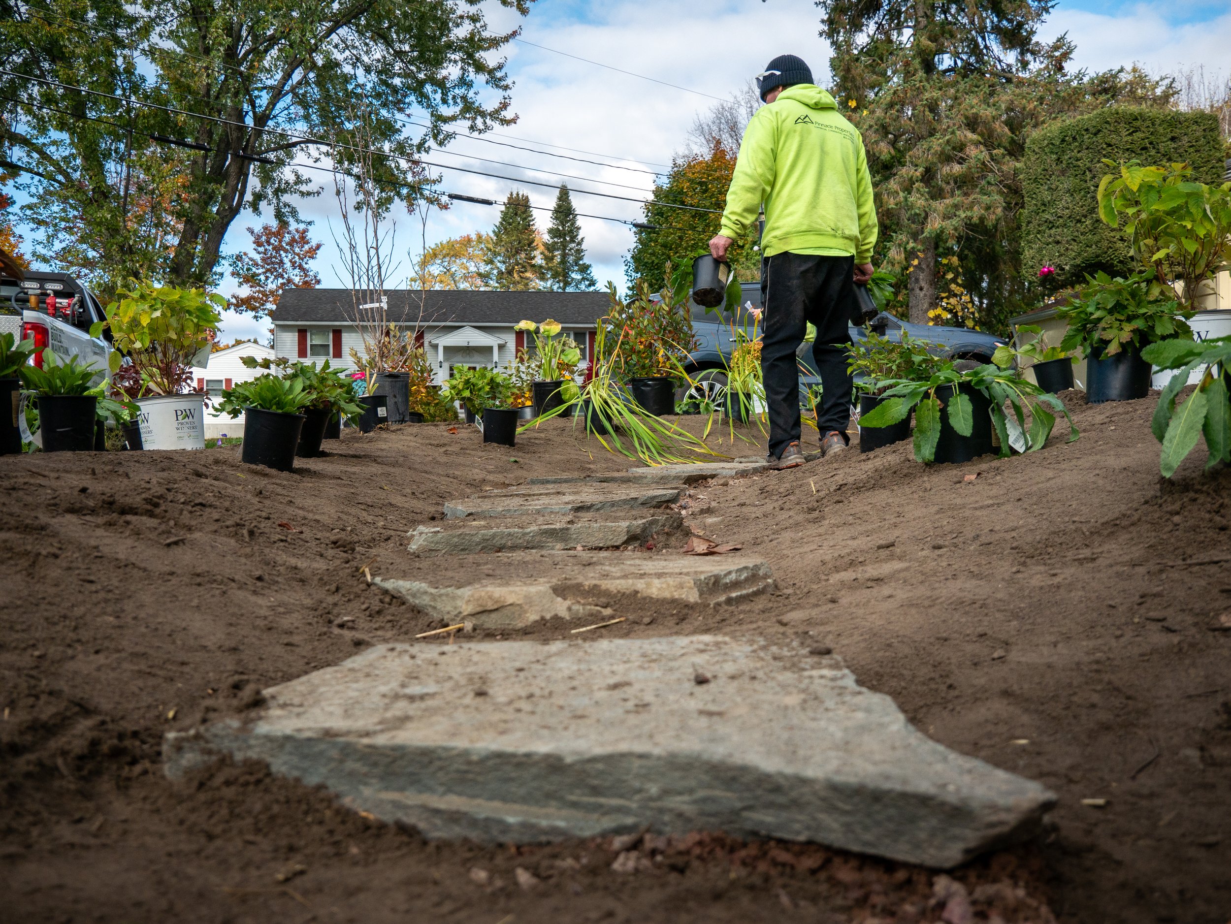pinnacle properties landscaper laying out plants for a landscape install