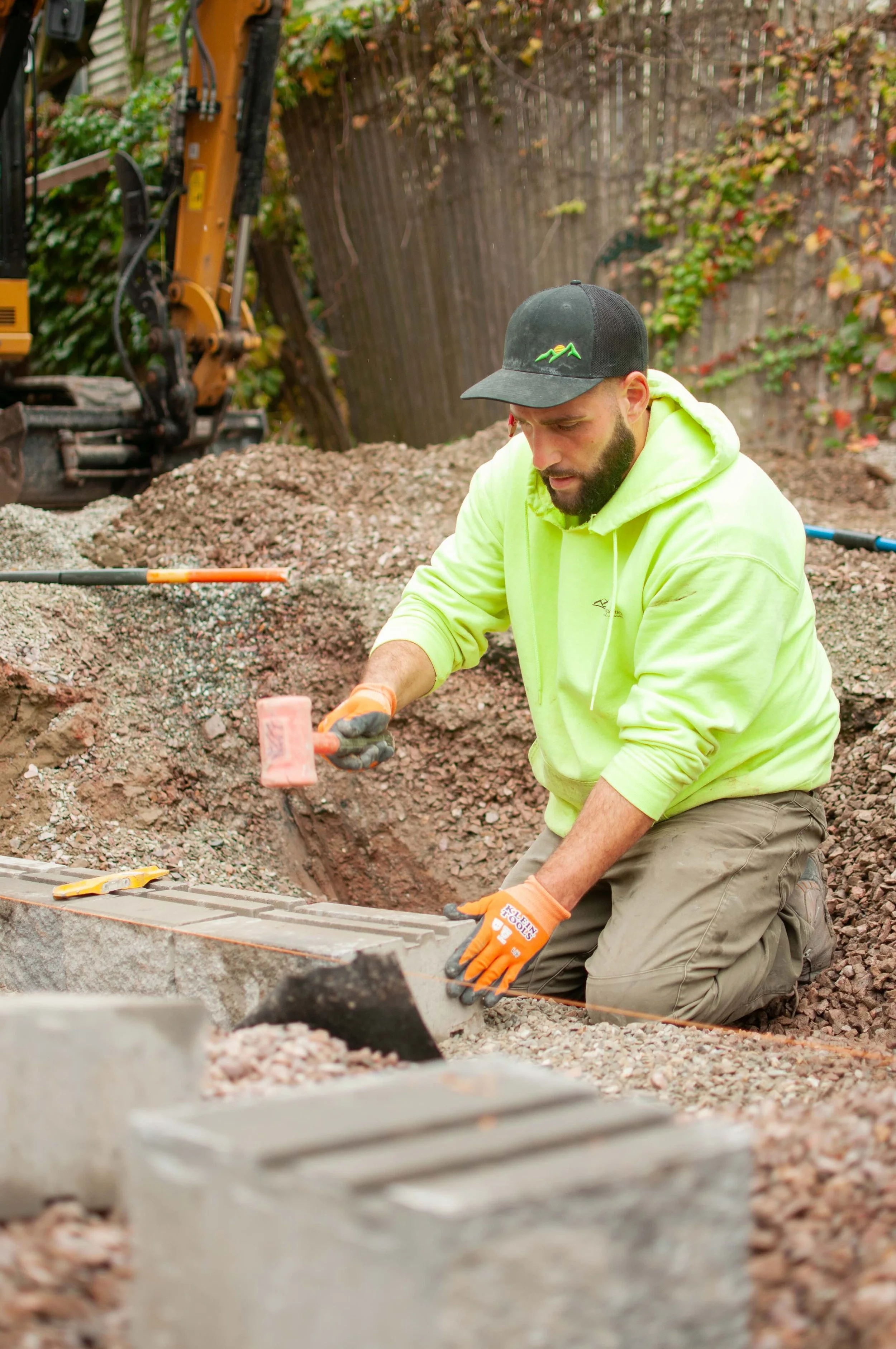 pinnacle properties worker leveling and installing patio pavers
