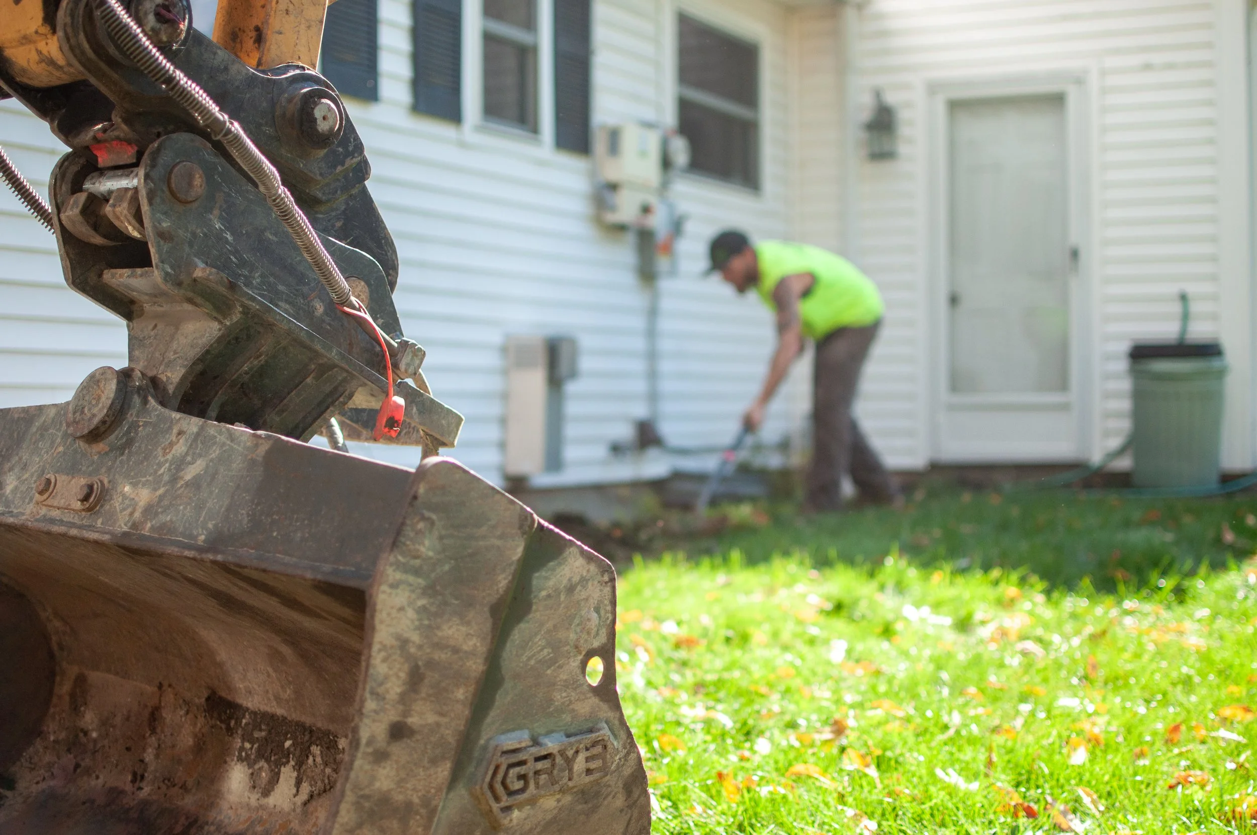 landscaper preparing a garden bed for planting