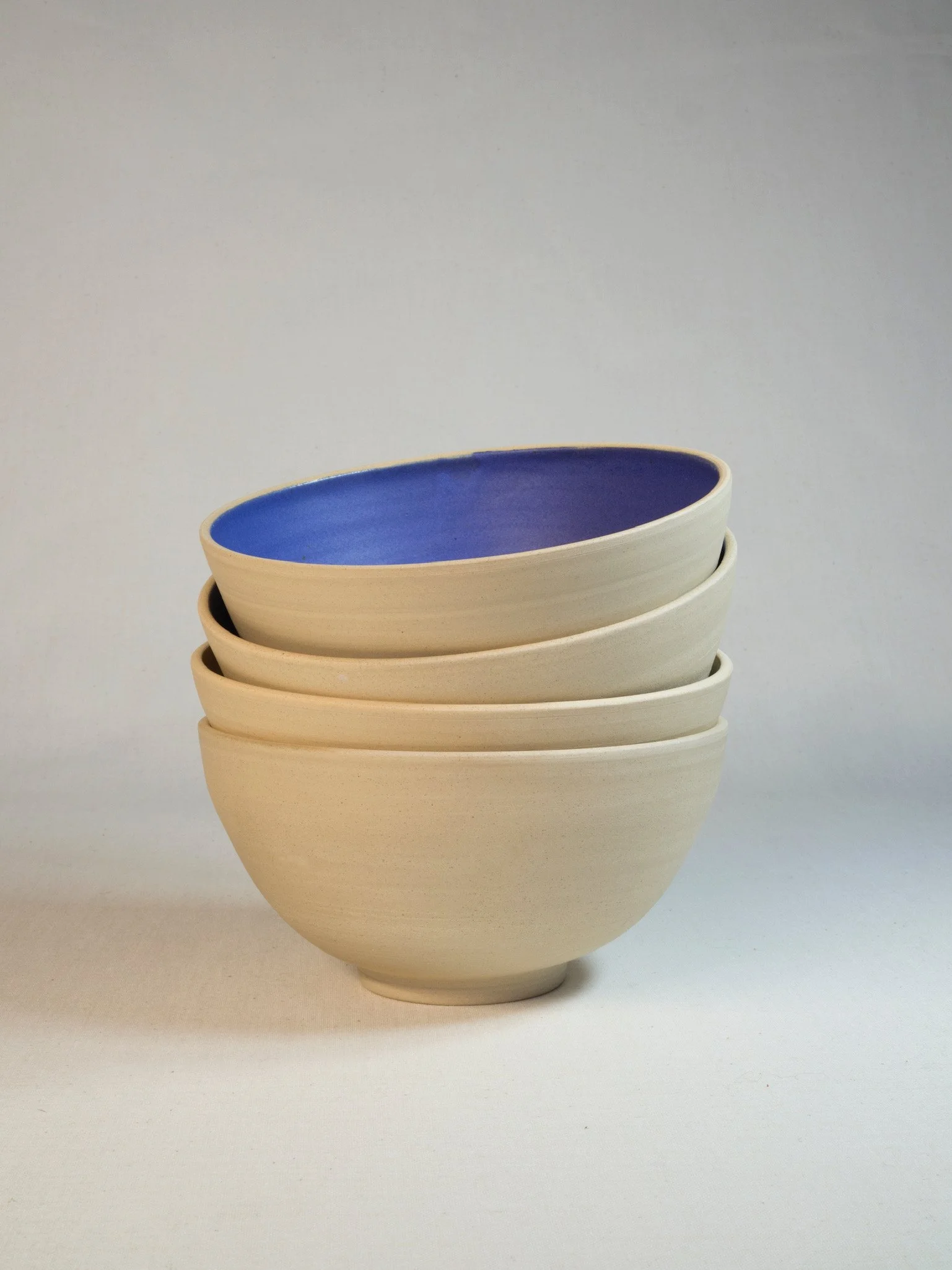 big ceramic bowls with blue glaze on the inside