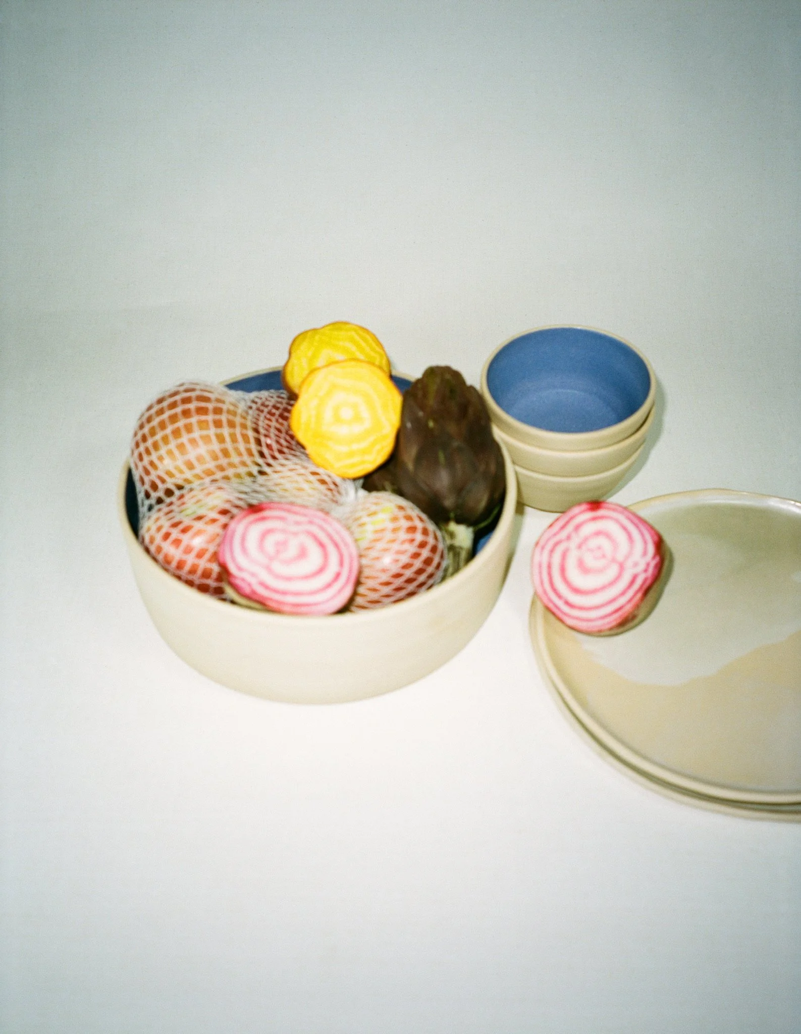 differently sized ceramic bowls and plates with food