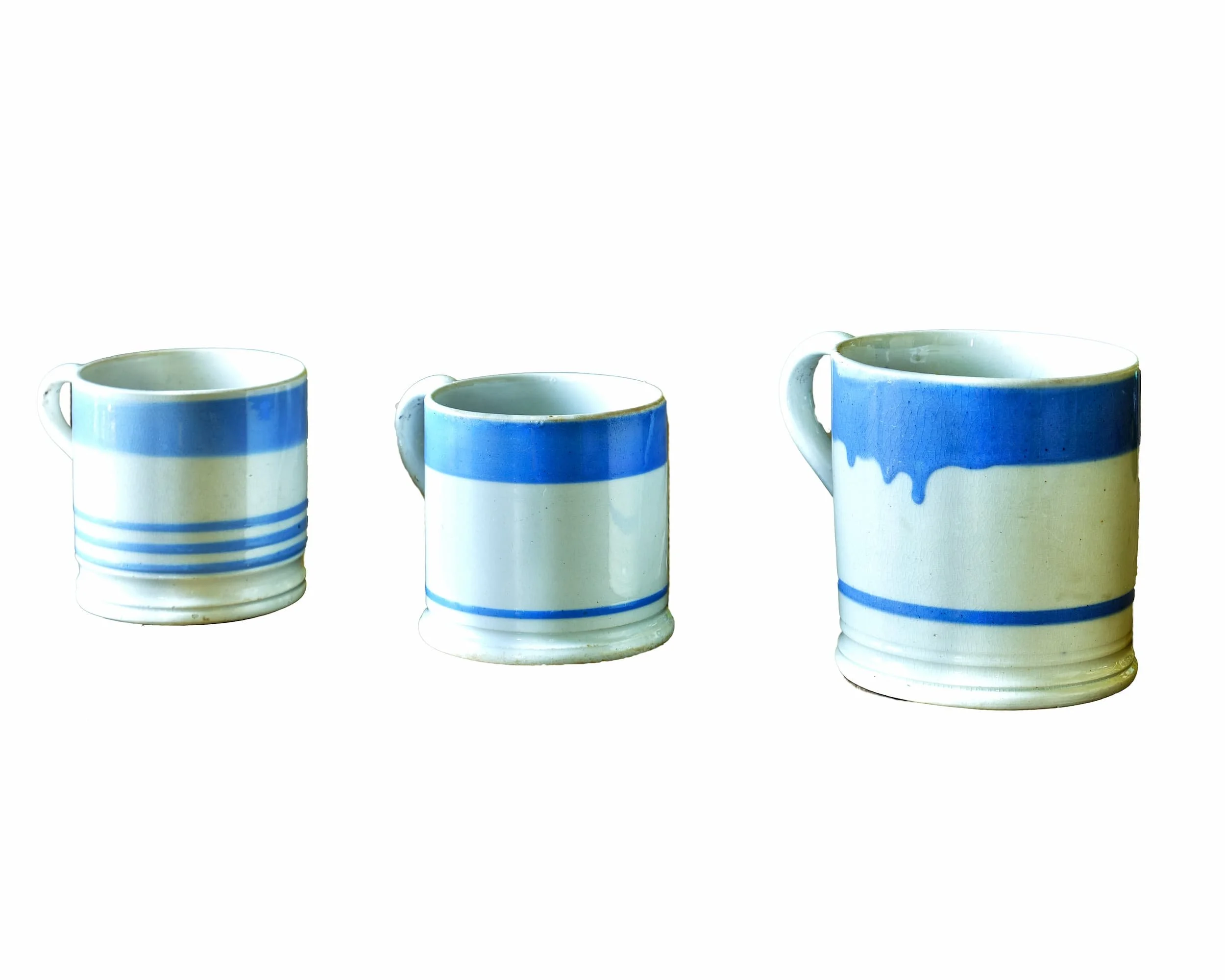 Three Blue and White Banded Pottery Mugs