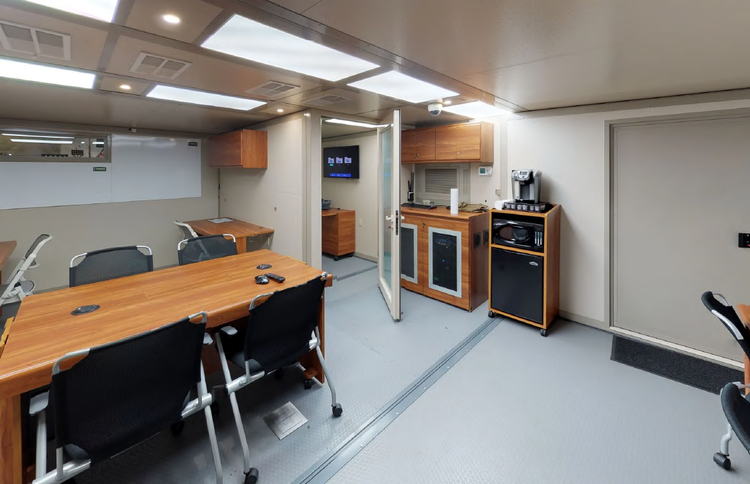 FORTS command-center interior from the 2026 catalog, showing meeting space, workspace and kitchenette