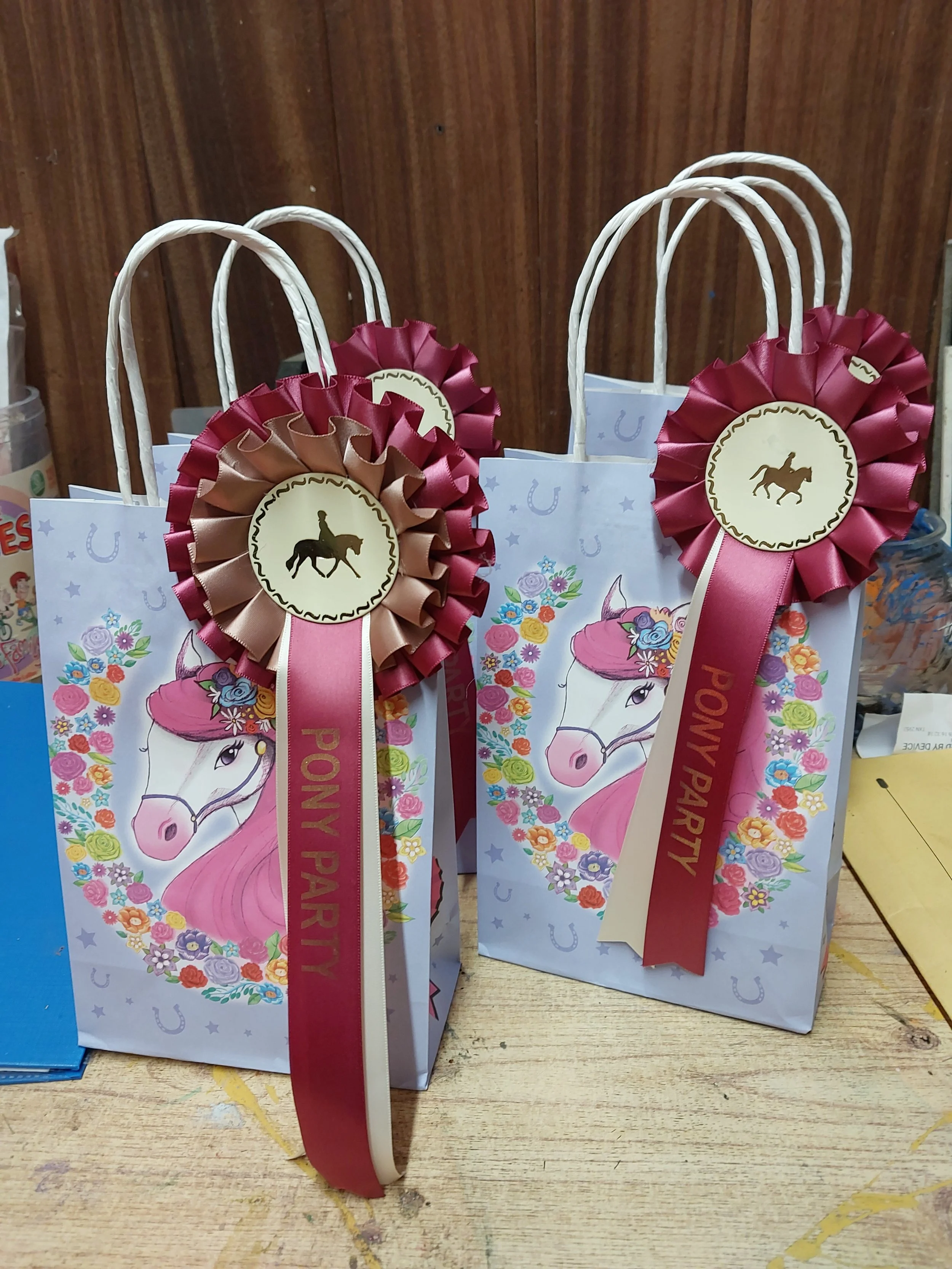 Horse riding birthday party bags and rosettes