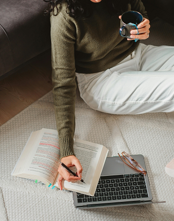 woman-studying-with-book-and-laptop