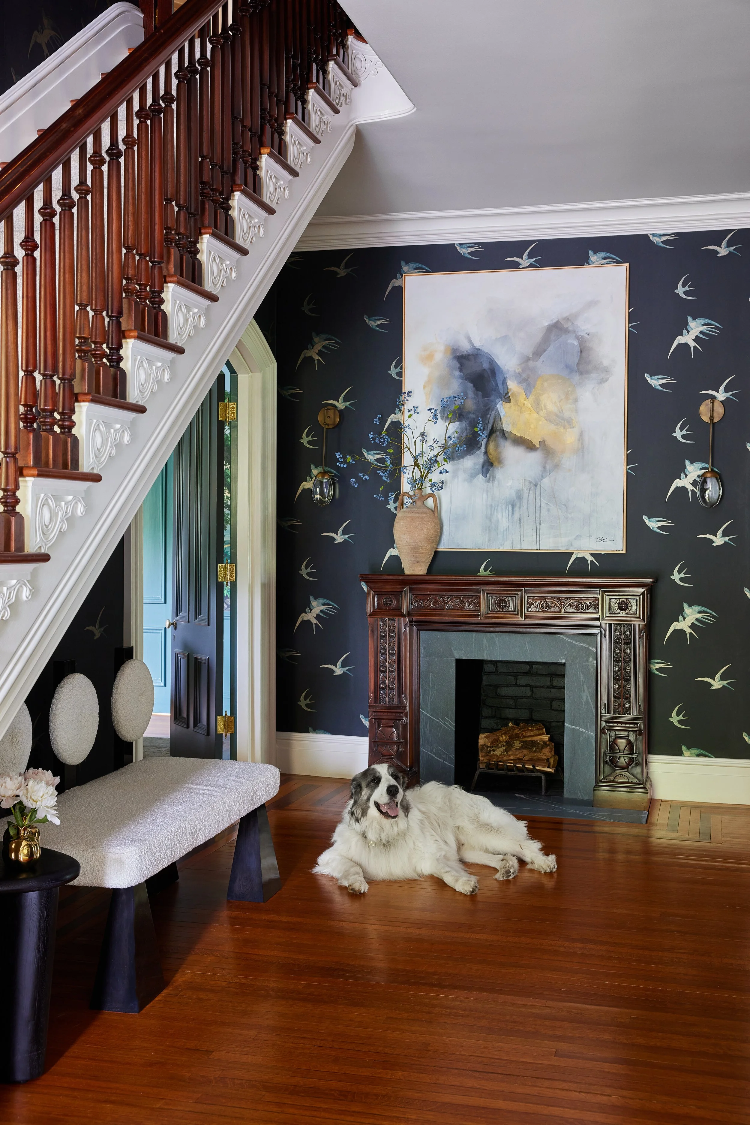 Atmopsheric painting displayed over mantal with dog 