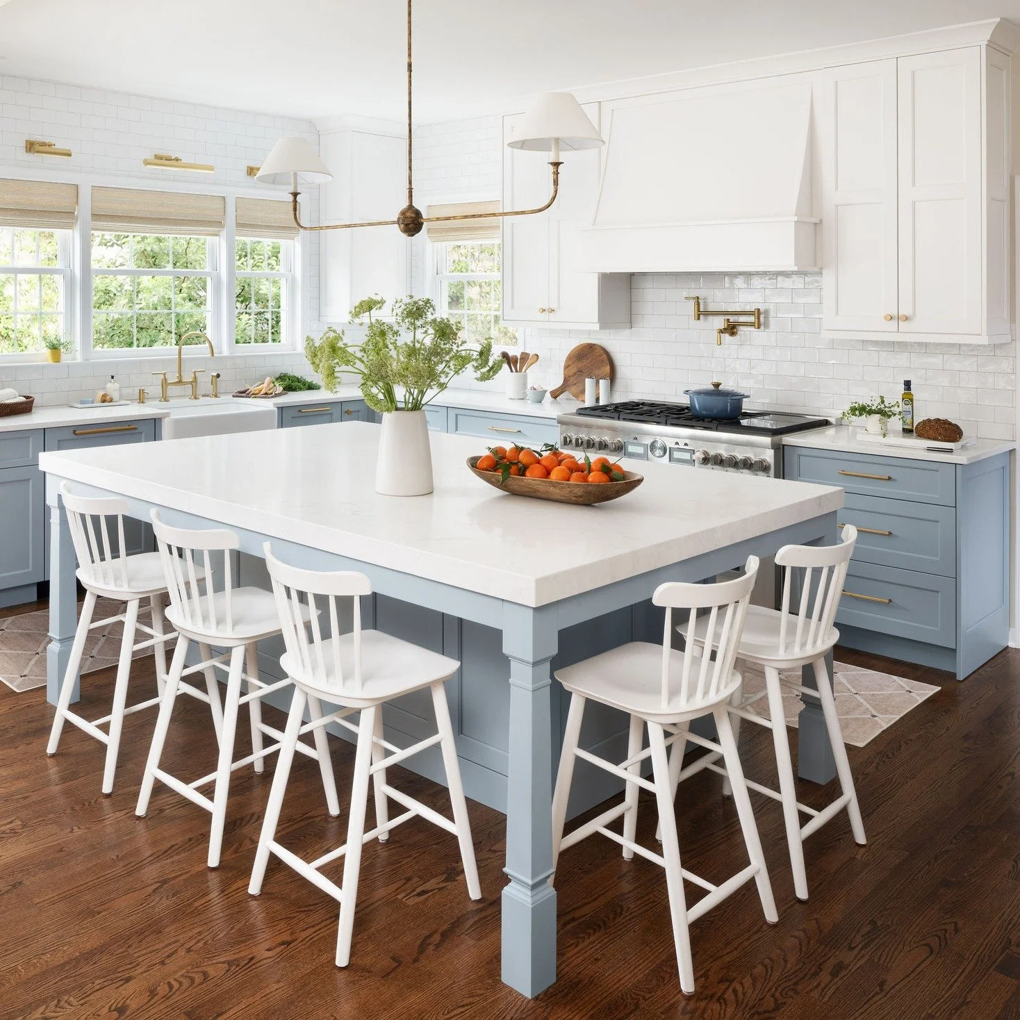 A little color, a lot of character. ✨

White perimeter cabinetry keeps the kitchen bright and timeless, while the blue island adds a fresh, inviting focal point. Tucked just beyond, the pantry in a greenish gray brings warmth, depth and the perfect t