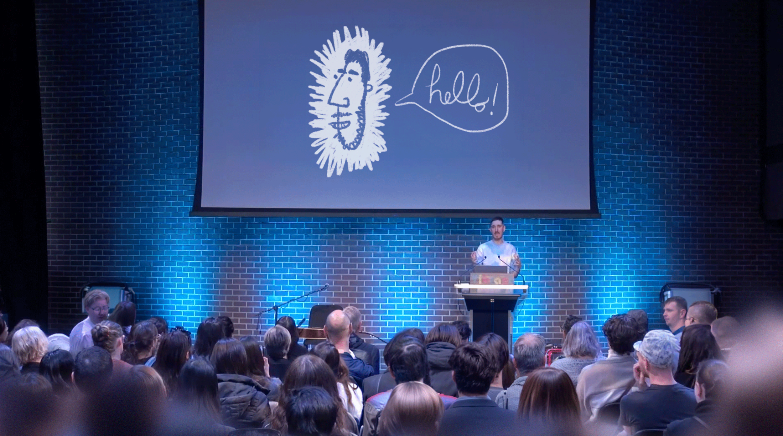 Dominic Prevost giving a keynote on creativity, purpose, and confidence.