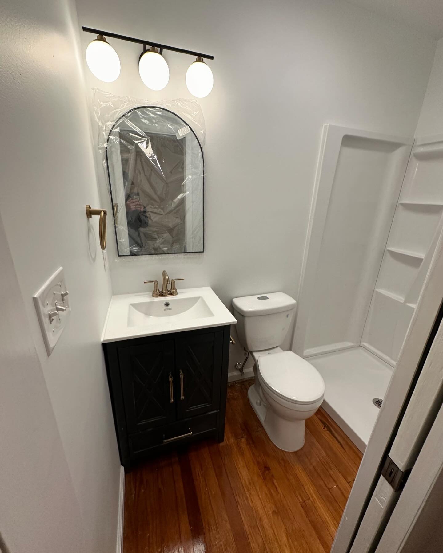 Full Bathroom built into this Woodberry homes master bedroom. Repurposed the closet door into the pocket door entrance to the bathroom.  Loved the clients choice to keep the original hardwood flooring for the new bathroom. LIVING IT UP!