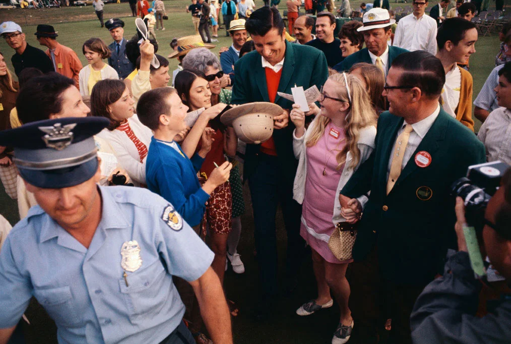 Here George is collecting business cards and names from his fans to send them autographs because he could not write them in person.