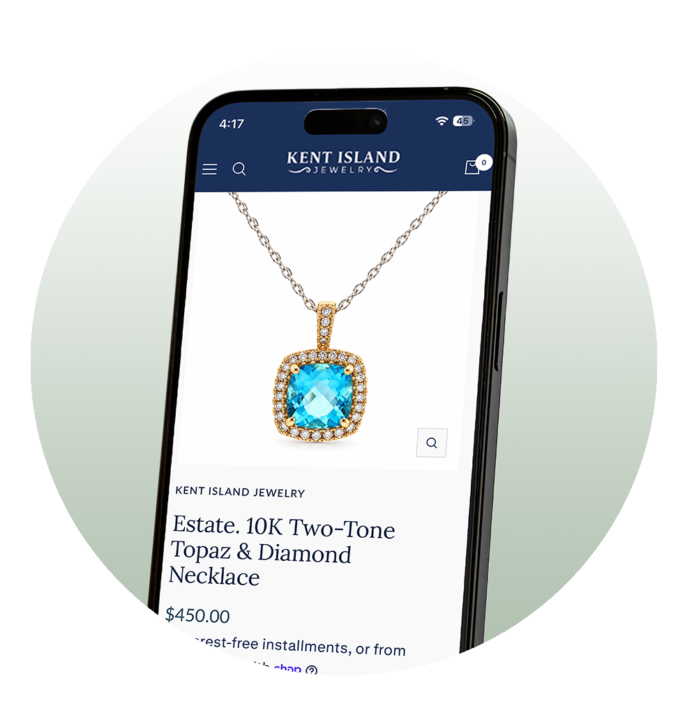 A phone inside a green circle displaying a sapphire necklace for sale on Kent Island Jewelry's website