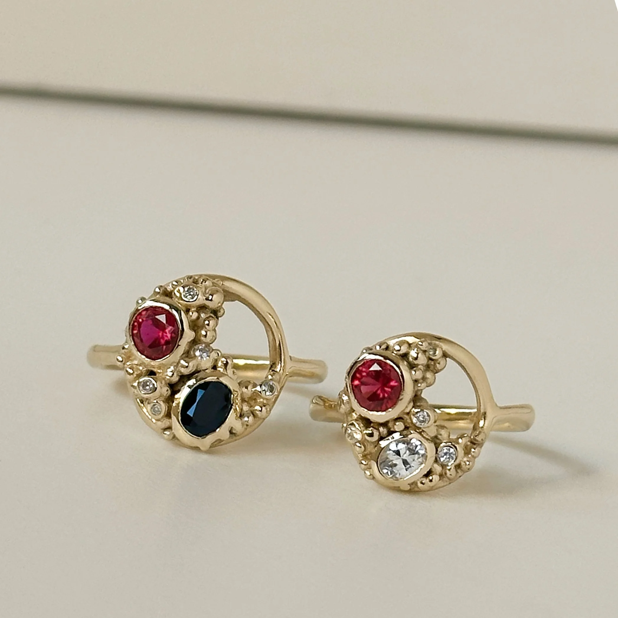 After transformation pair of open circle cluster gold and gemstone rings 1.jpg
