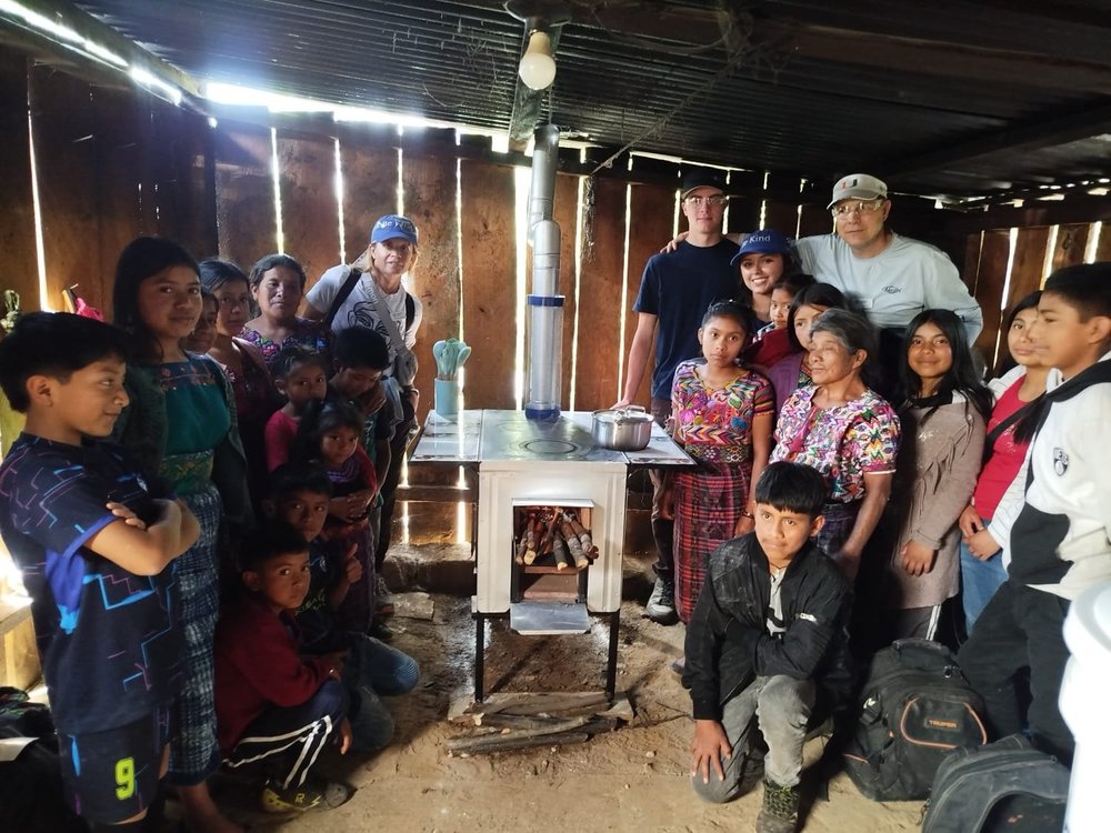 Jonnathan, an IEP Impacting Homes installer, working with a family during a stove installation in rural Guatemala