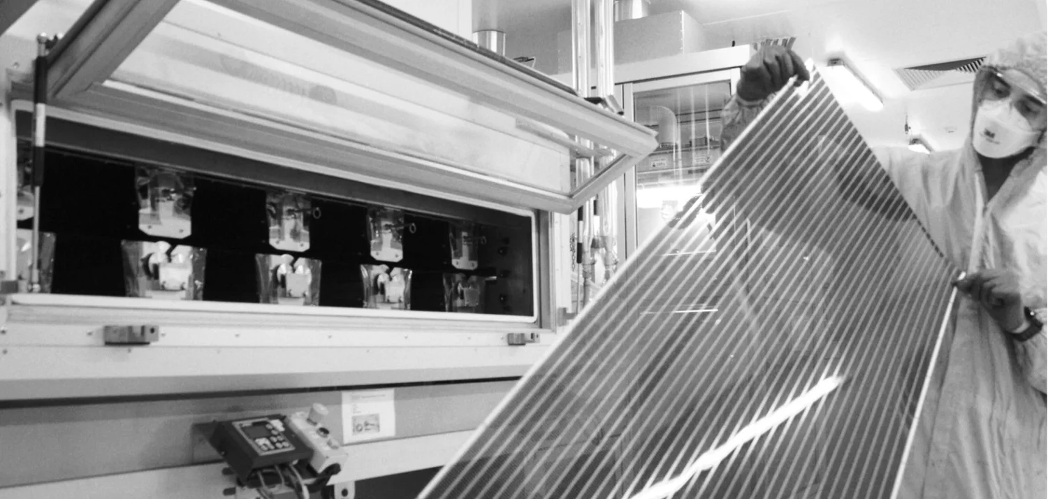 ORENgE technician holding printed semiconductor film in the cleanroom