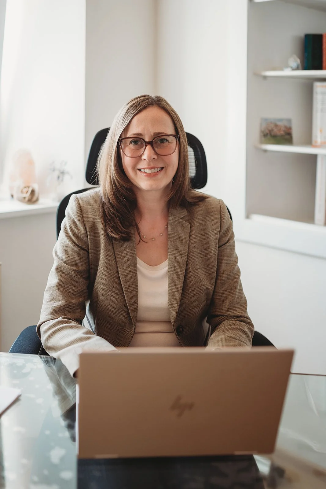 Client attending online therapy session for life transitions on laptop at home