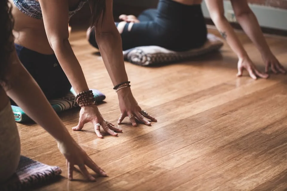 Close-up of a person walking on pavement, focusing on their athletic shoe and leaving a trail of footsteps in a park or outdoor setting.