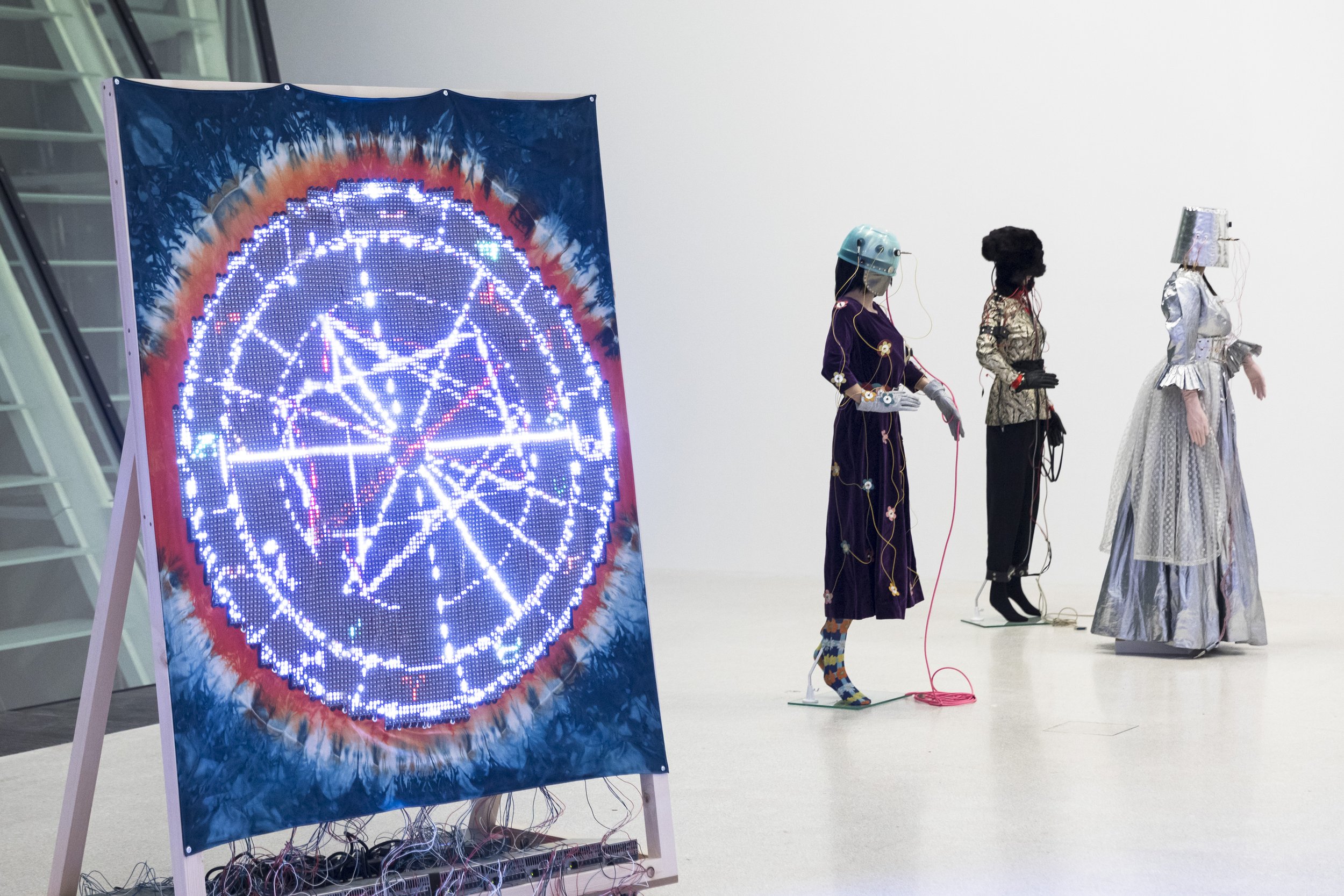  Ei Arakawa,  Performance People,  2018/2019 (left), and Suzanne Treister,  Rosalind Brodsky’s Electronic Time Travelling Costumes , 1995-1997 exhibition view  HOPE . Museion 