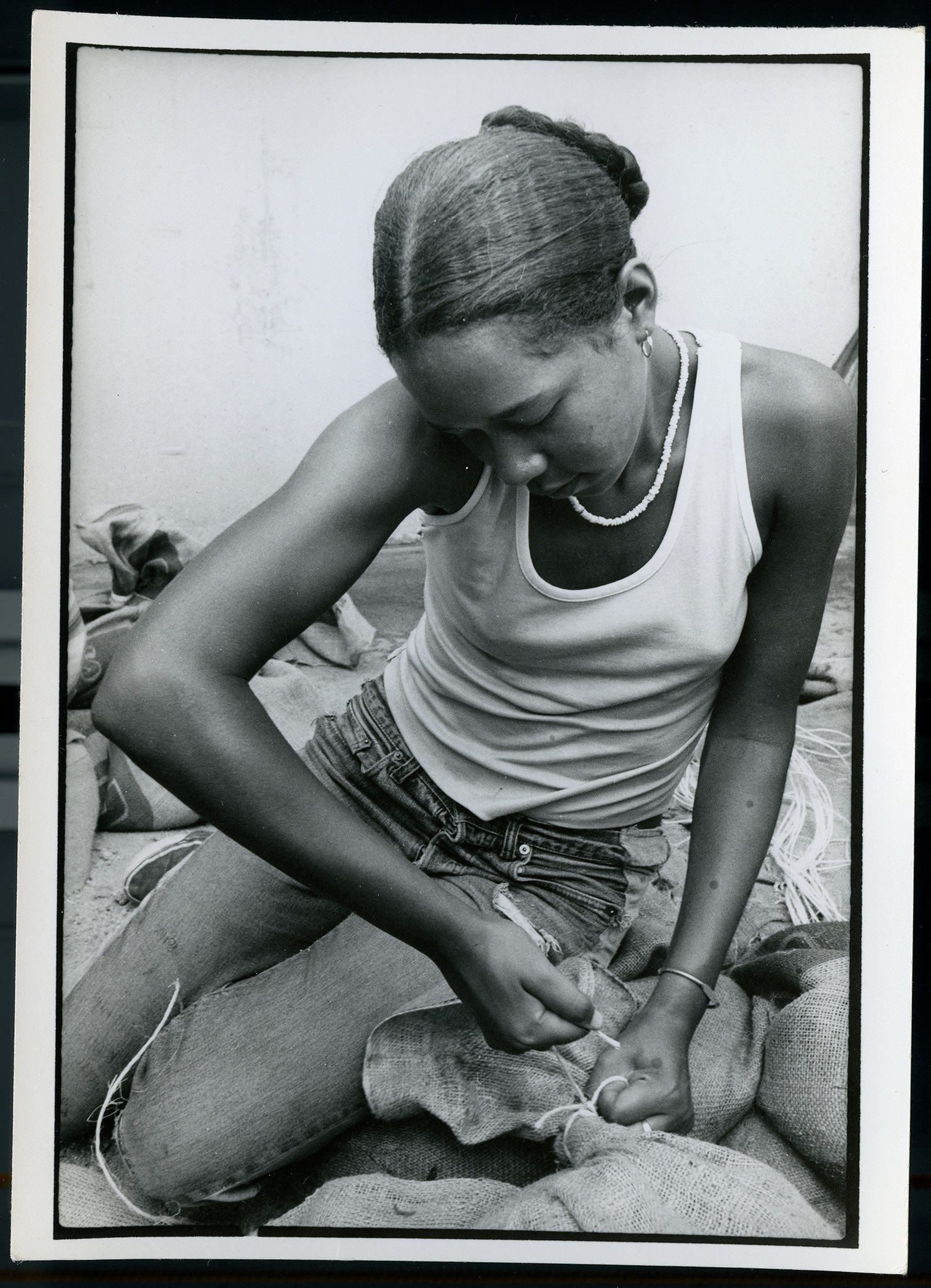  Tying a sandbag during the production of  The Great Wall of Los Angeles , © SPARC 1976, courtesy of Judith F. Baca and the SPARC archives. Photo: Linda Eber, 1976.&nbsp; 
