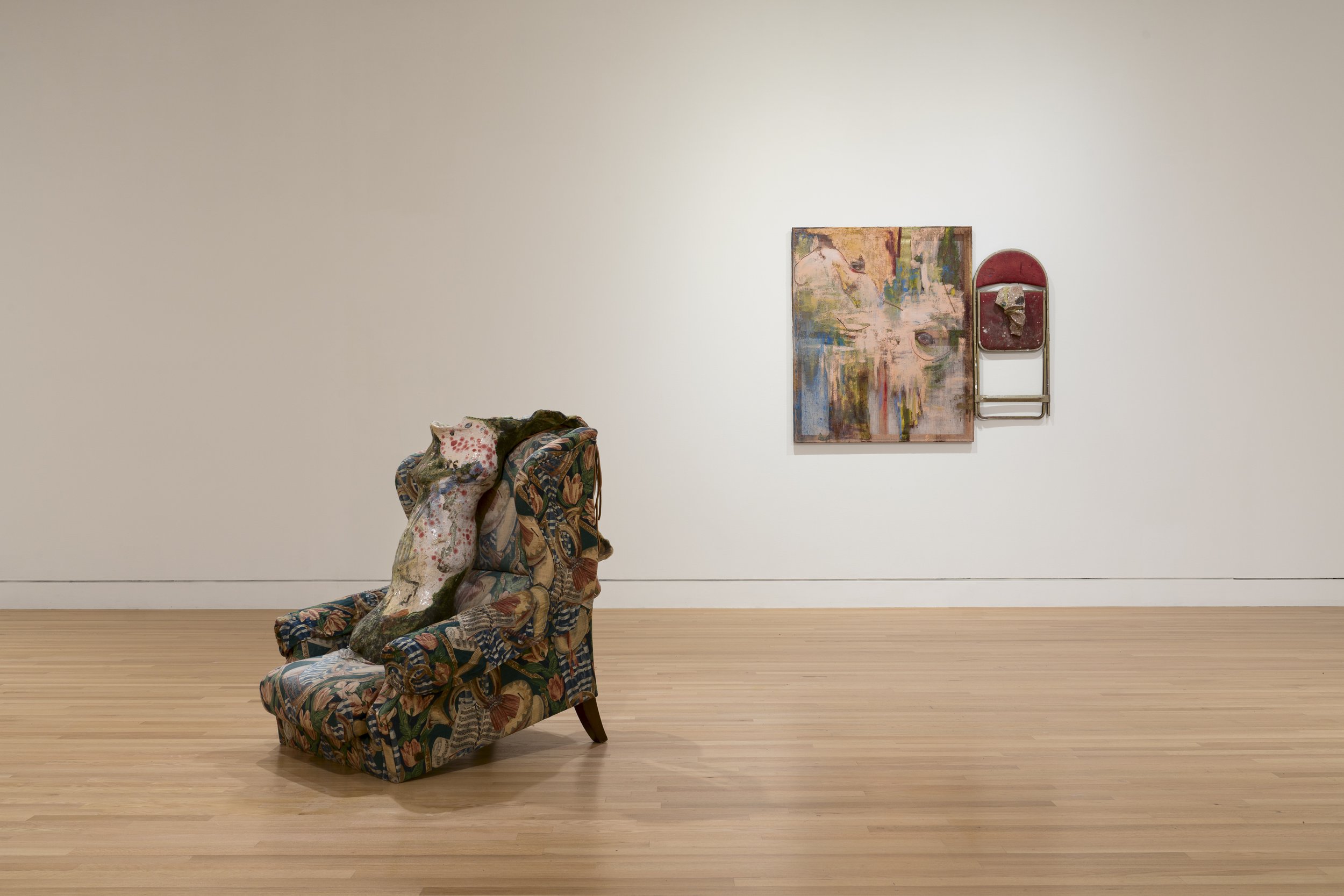  From left: Lascaux Reprise, 2012/2018. Glazed ceramic, upholstered chair, leather, fabric.  45 x 40 x 59 in. Courtesy of the artist and Adams and Ollman, Portland. Third Eye, 2015. Acrylic paint, collage,  fabric, ceramic, chair. 56 x 47 1/2 x 6 in.