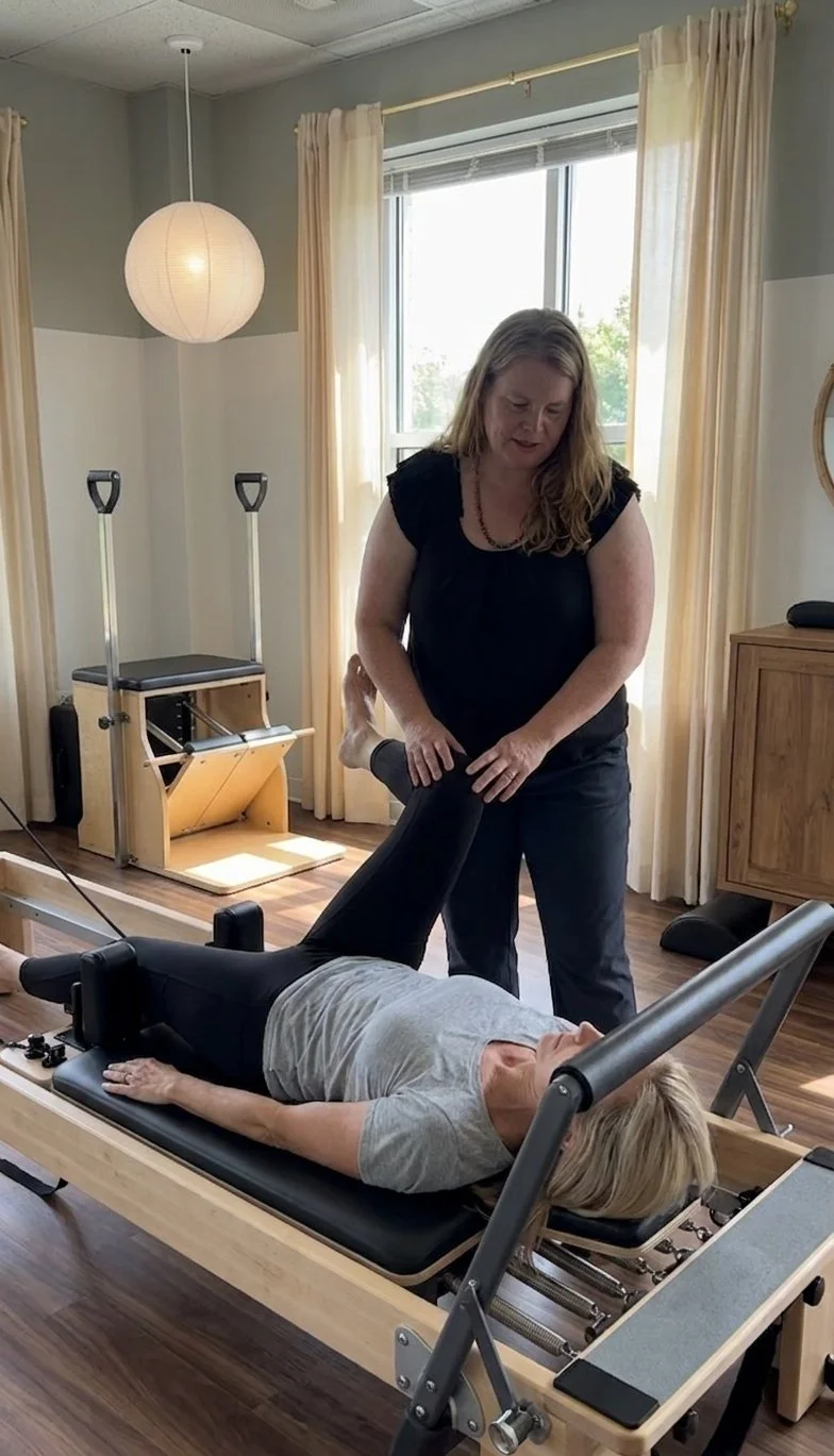 Patient working with a provider at a Pilates physical therapy clinic in Charlotte, NC during a one-on-one rehabilitation session
