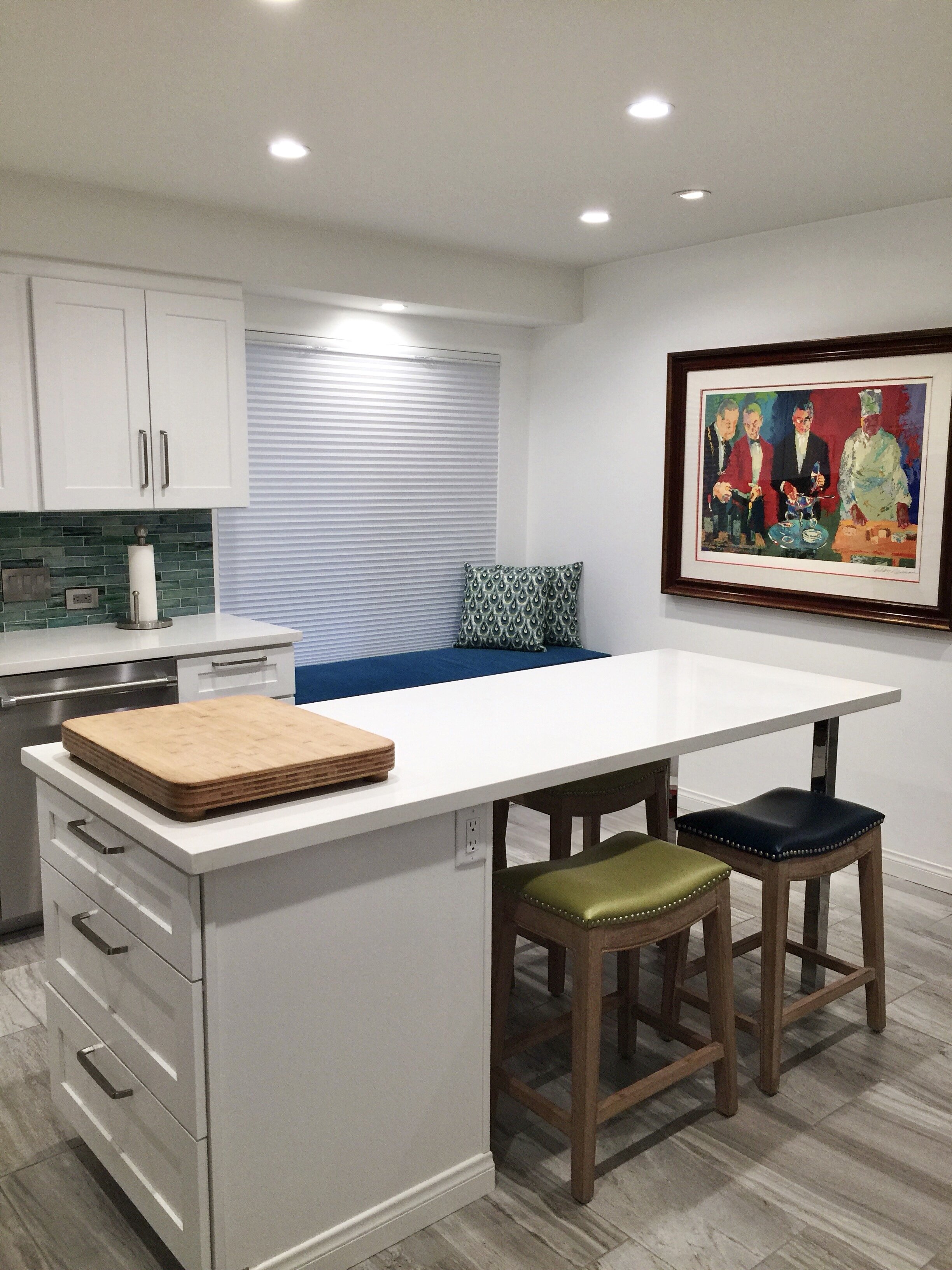 Modern eclectic kitchen with white cabinetry and a green tile backsplash by Gin Treadwell Interiors in Santa Clarita.