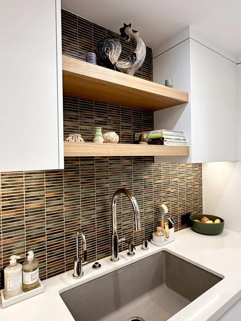 Organic modern wet bar with open wood shelving and a tile backsplash by Gin Treadwell Interiors in Santa Clarita.