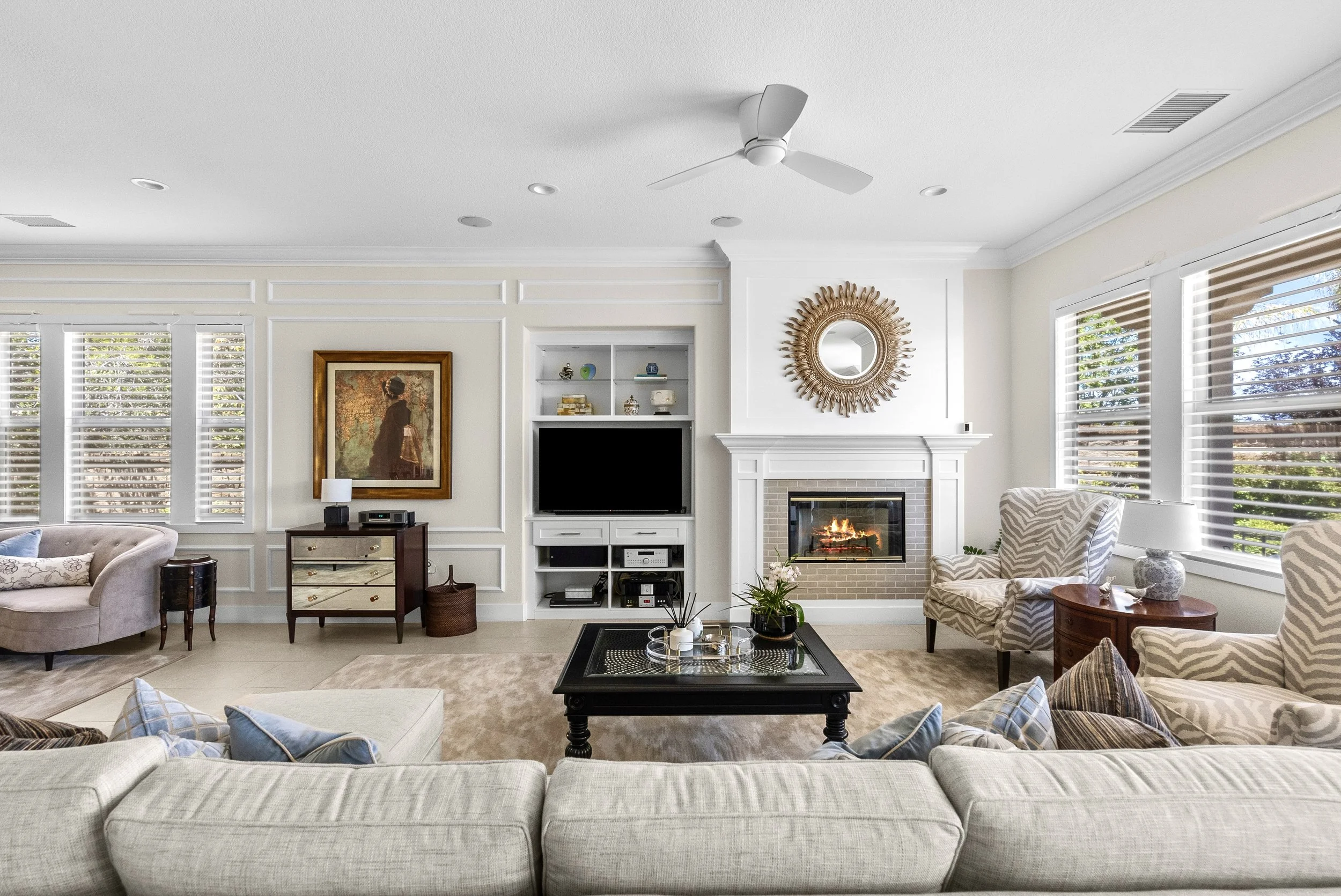 Traditional living room with a layered sectional, fireplace, and classic furnishings by Gin Treadwell Interiors in Santa Clarita.