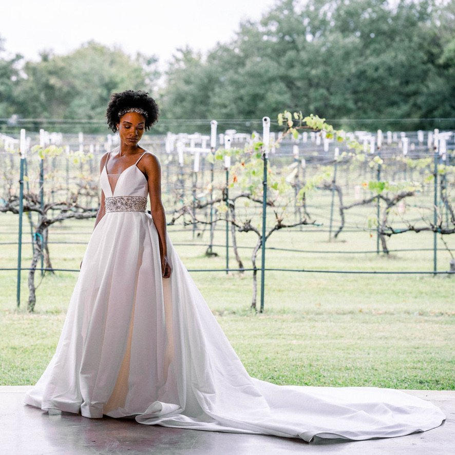 Justin Alexander 9878
Ballgown with deep, plunging neckline, hand beaded waistband, knife pleats faille
Size 10 & 32 $1127